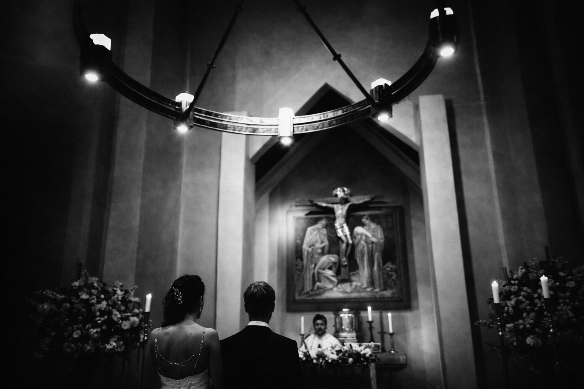 a bride and groom walking on a hill