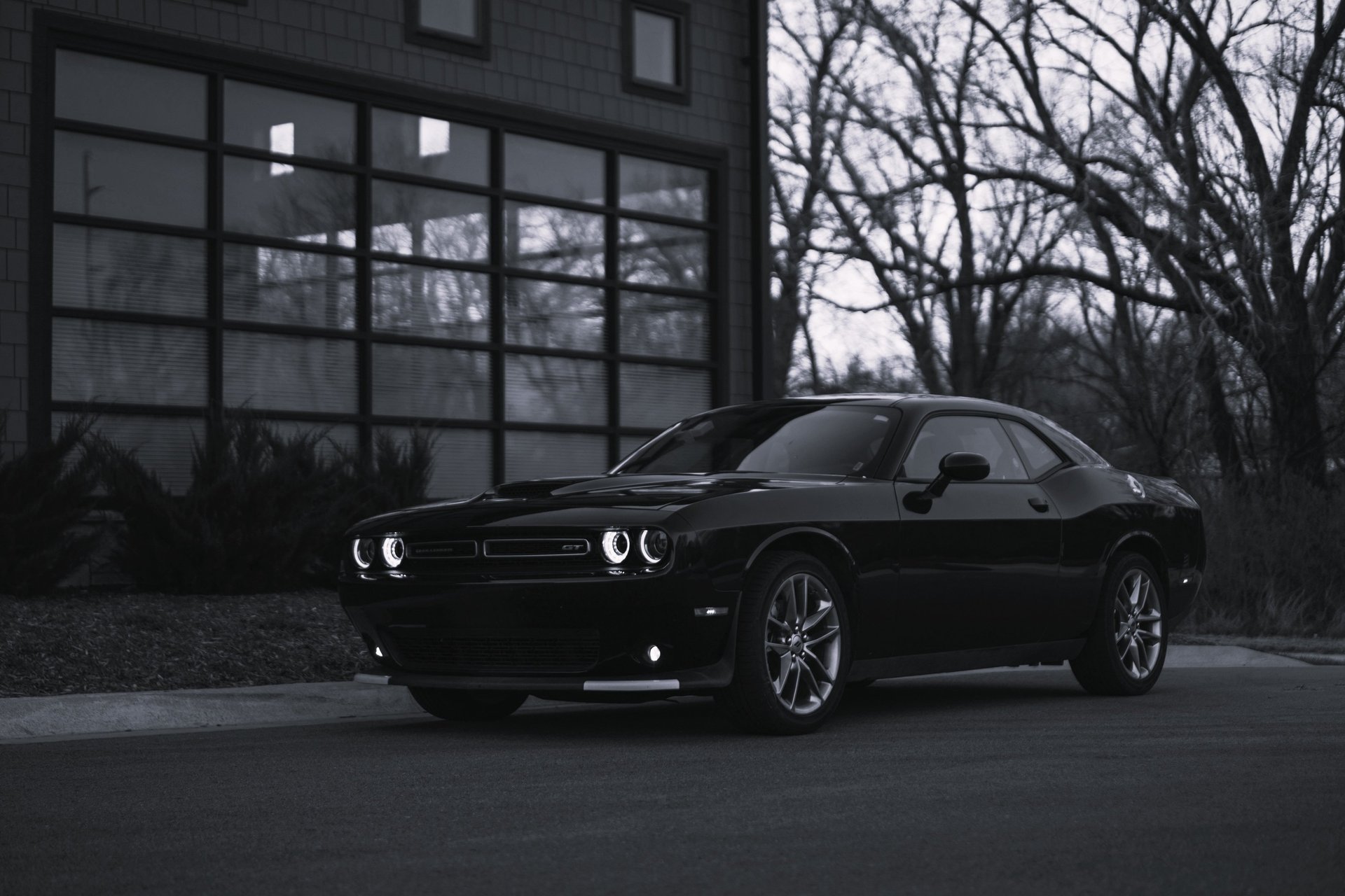 a white sports car parked in a parking lot