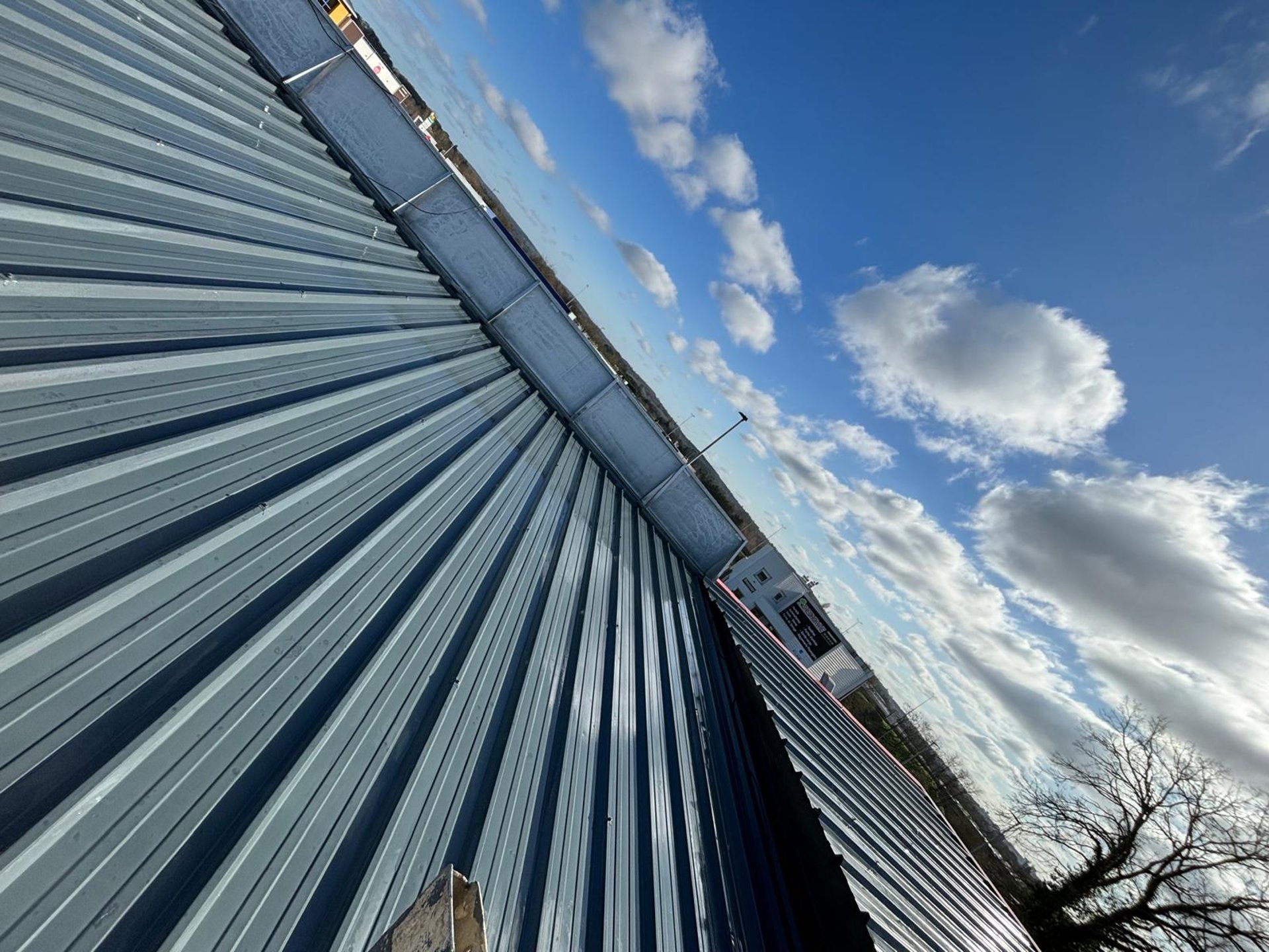 an abstract photo of a curved building with a blue sky in the background