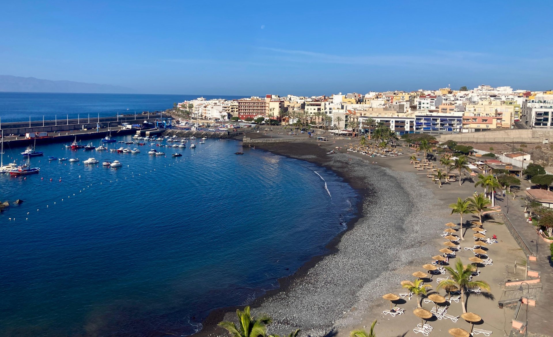 photography of mountain cliff beside seashore during daytime