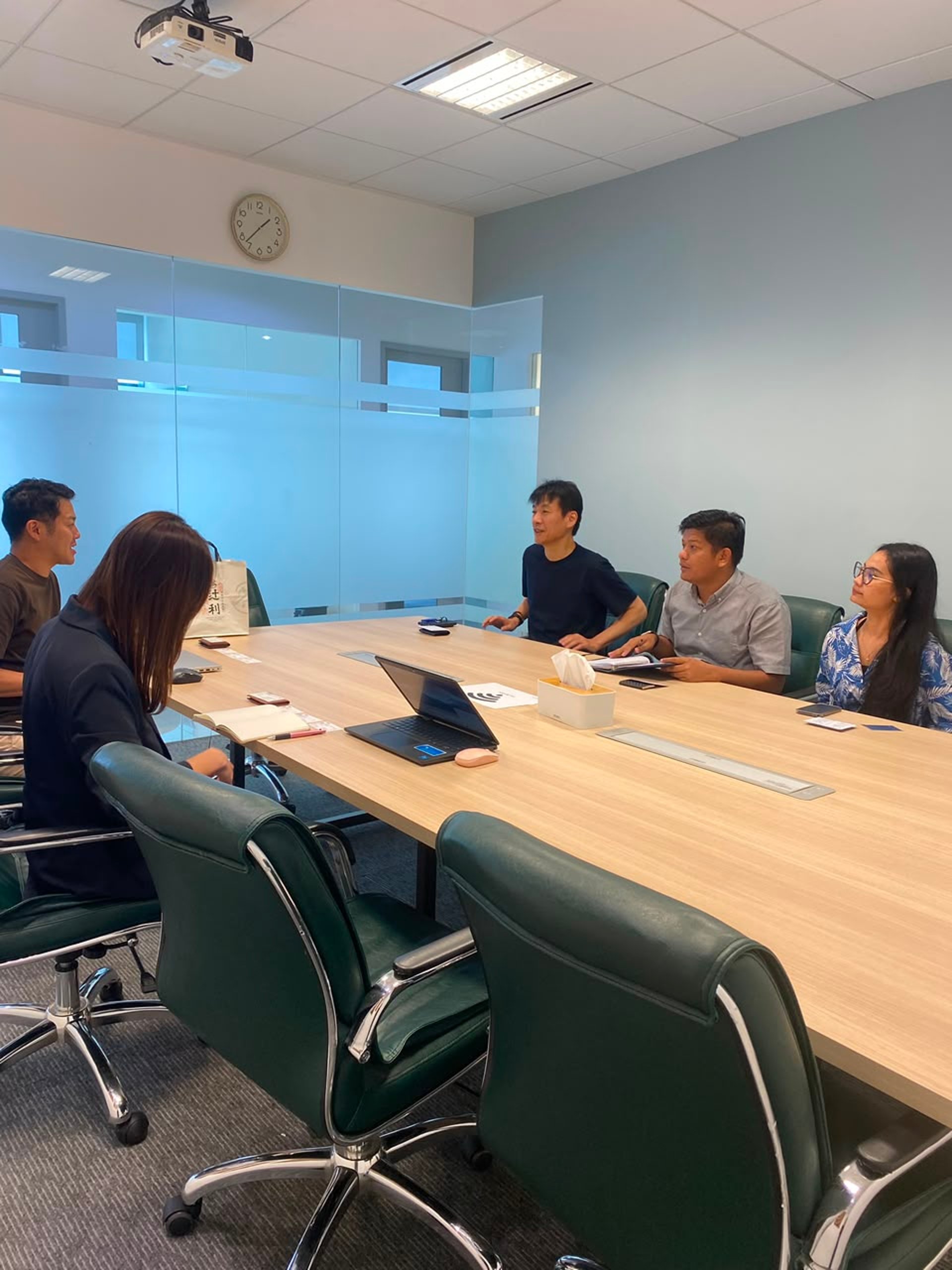 Business professionals collaborating around a conference table.