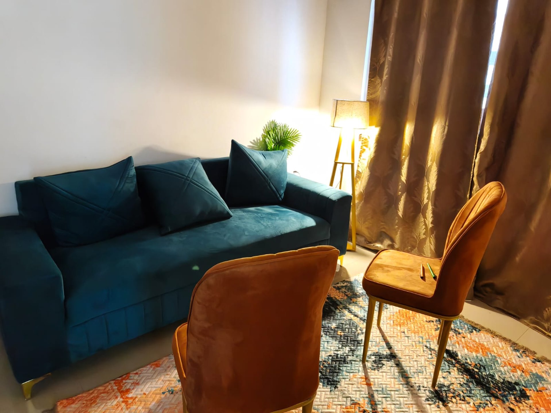 a brown leather couch sitting in front of a white wall