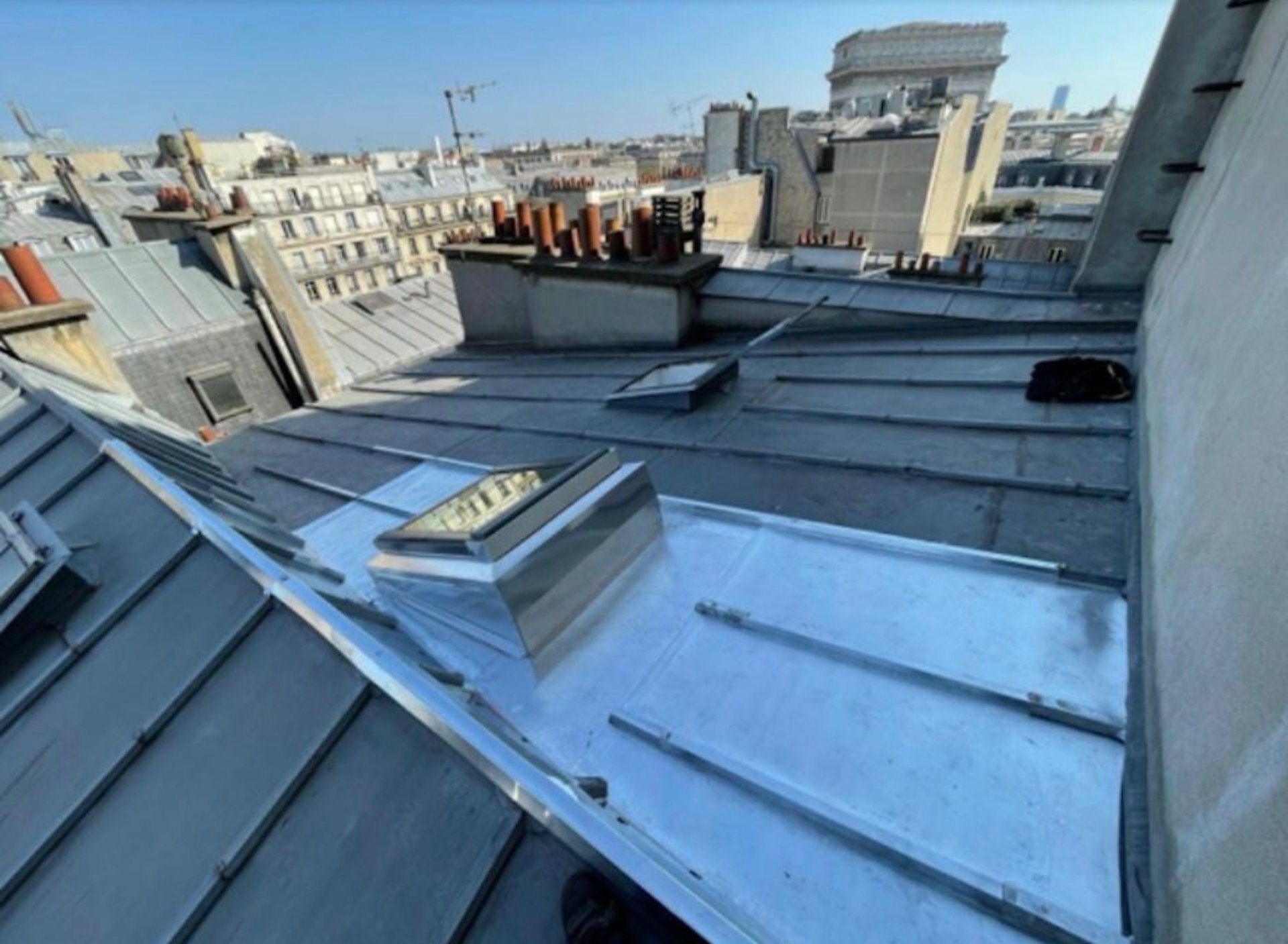 Roof tiles being laid on a wooden frame.