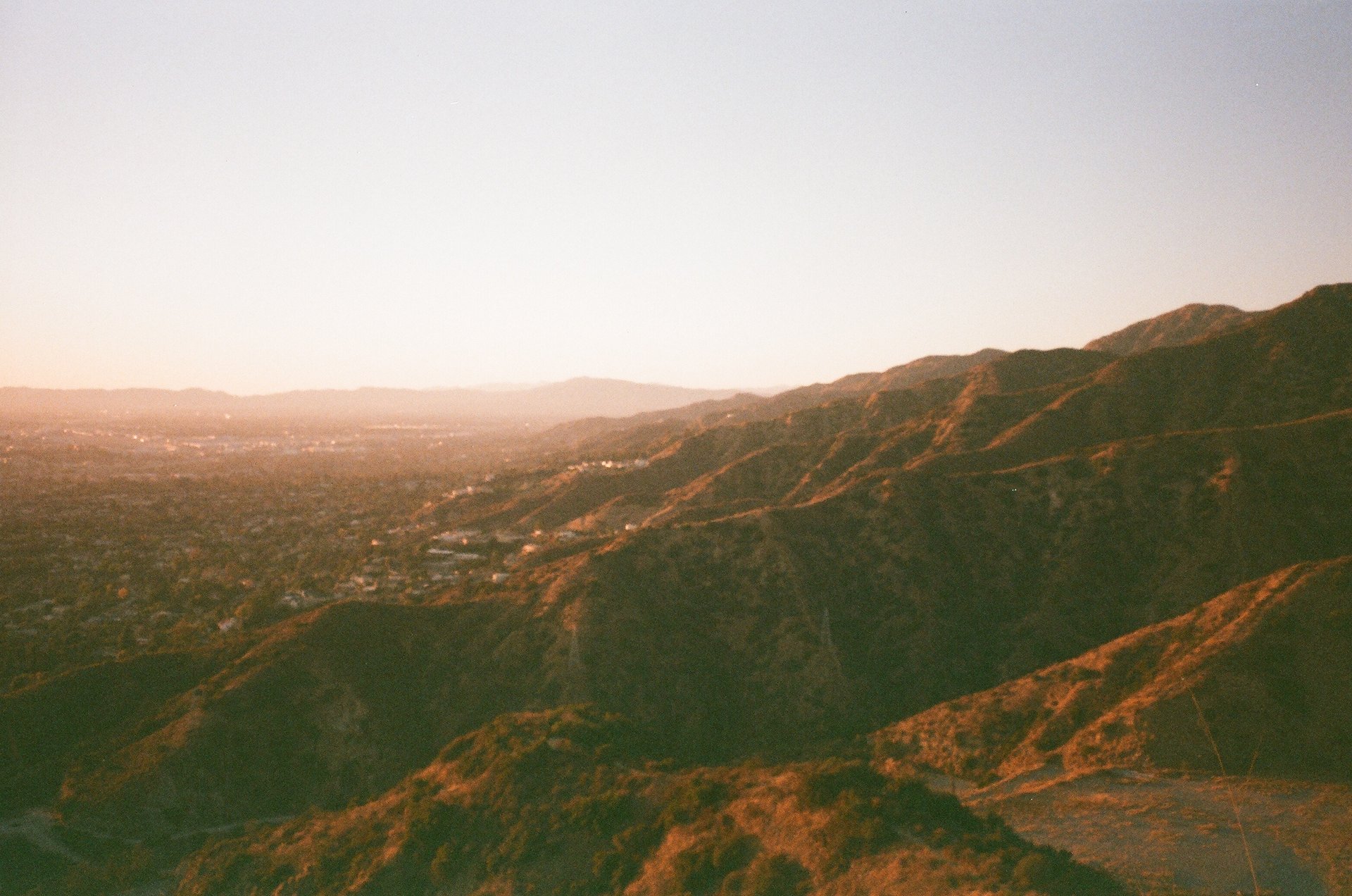 an abstract photo of a curved building with a blue sky in the background