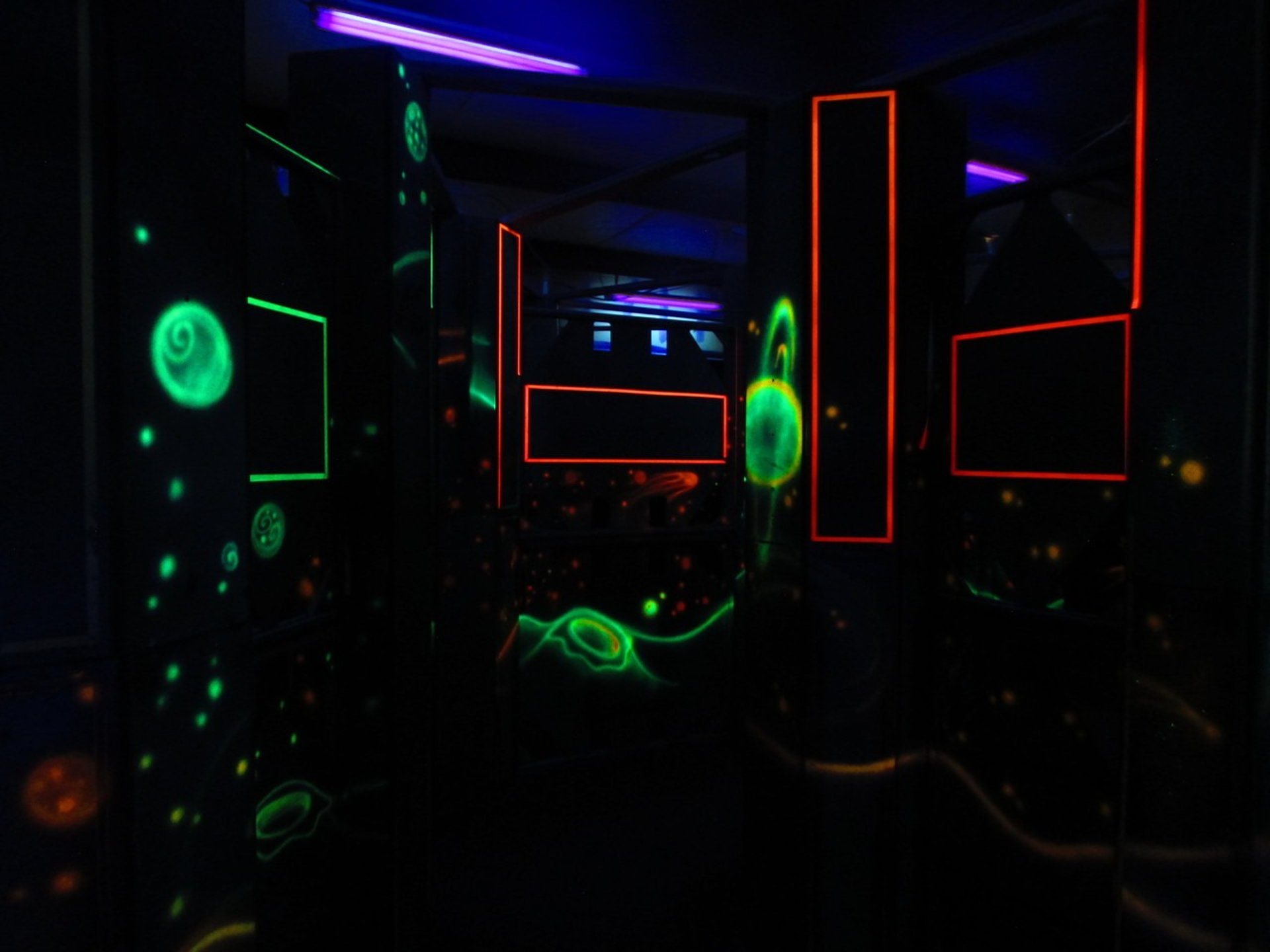 dark laser tag arena with glowing decorations