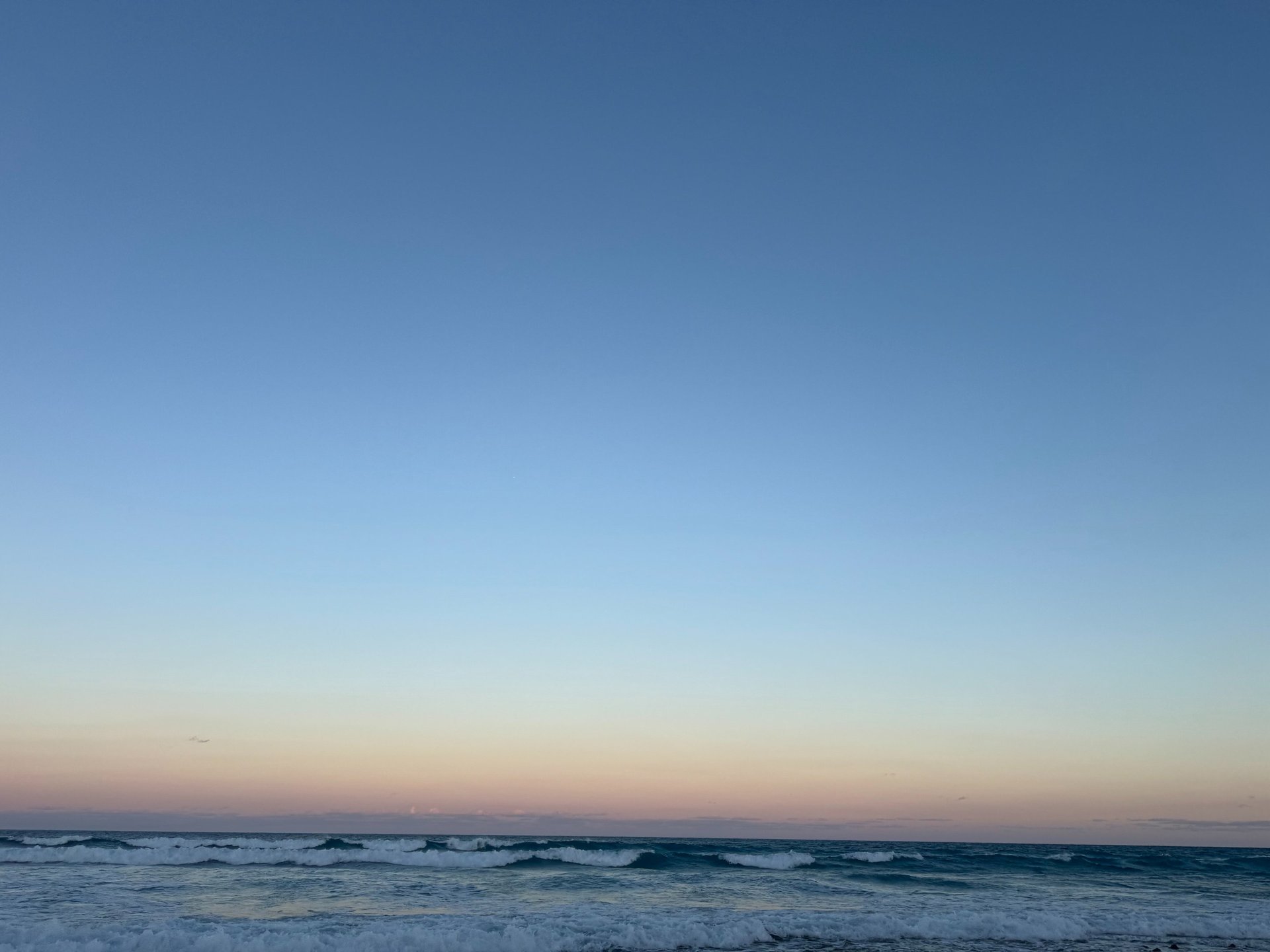 body of water under cloudy sky