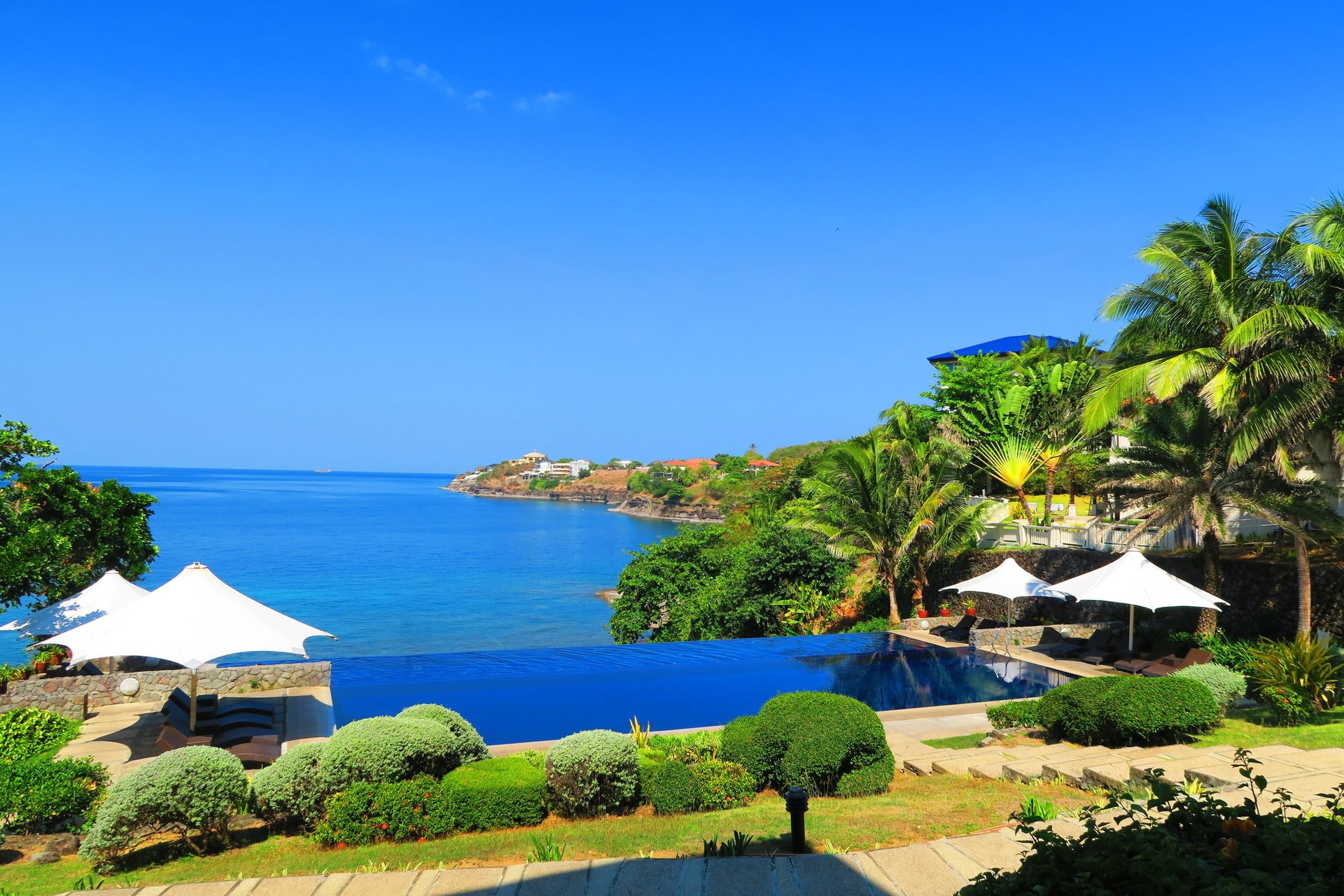 an abstract photo of a curved building with a blue sky in the background
