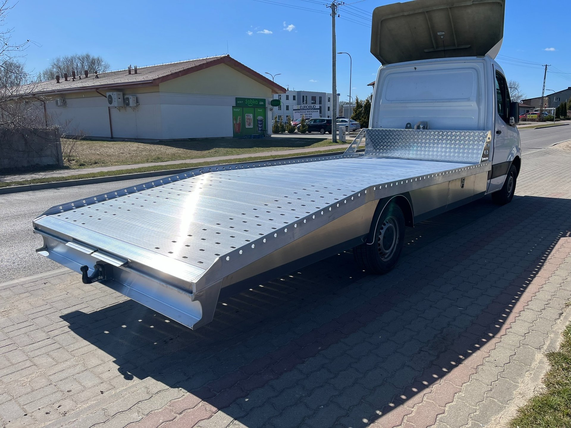 an abstract photo of a curved building with a blue sky in the background