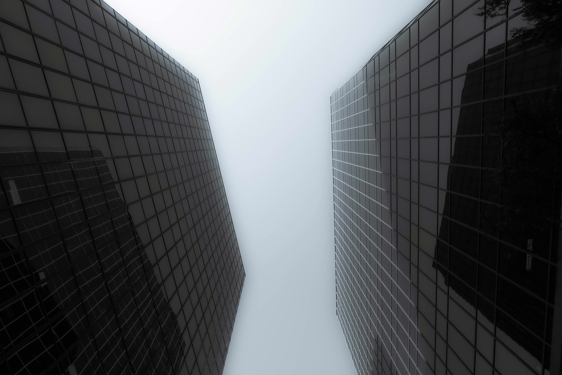 an abstract photo of a curved building with a blue sky in the background
