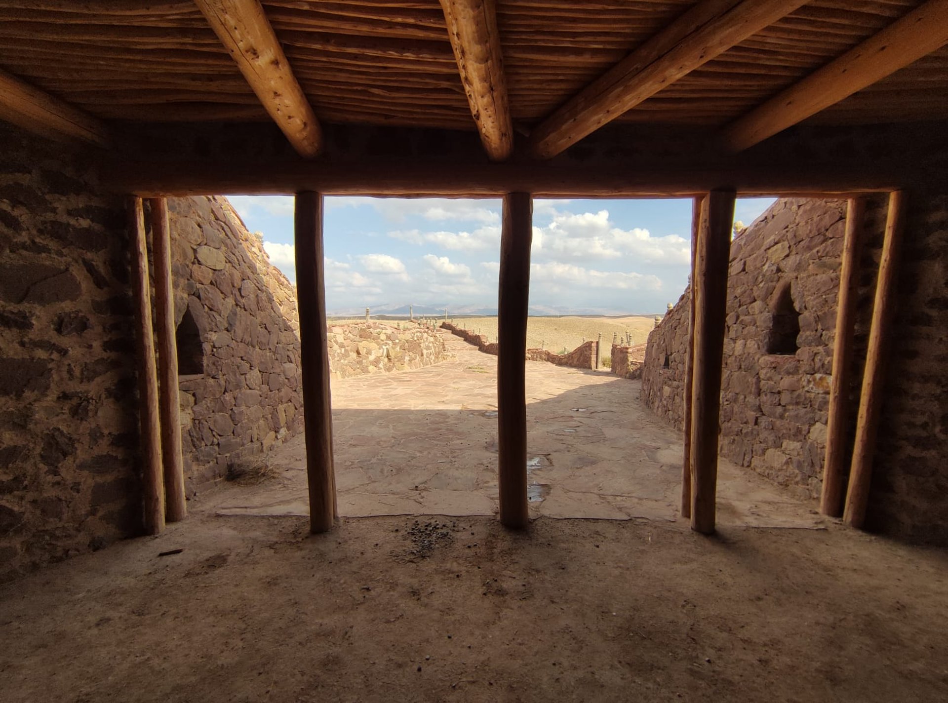 a view of a desert with a body of water in the distance