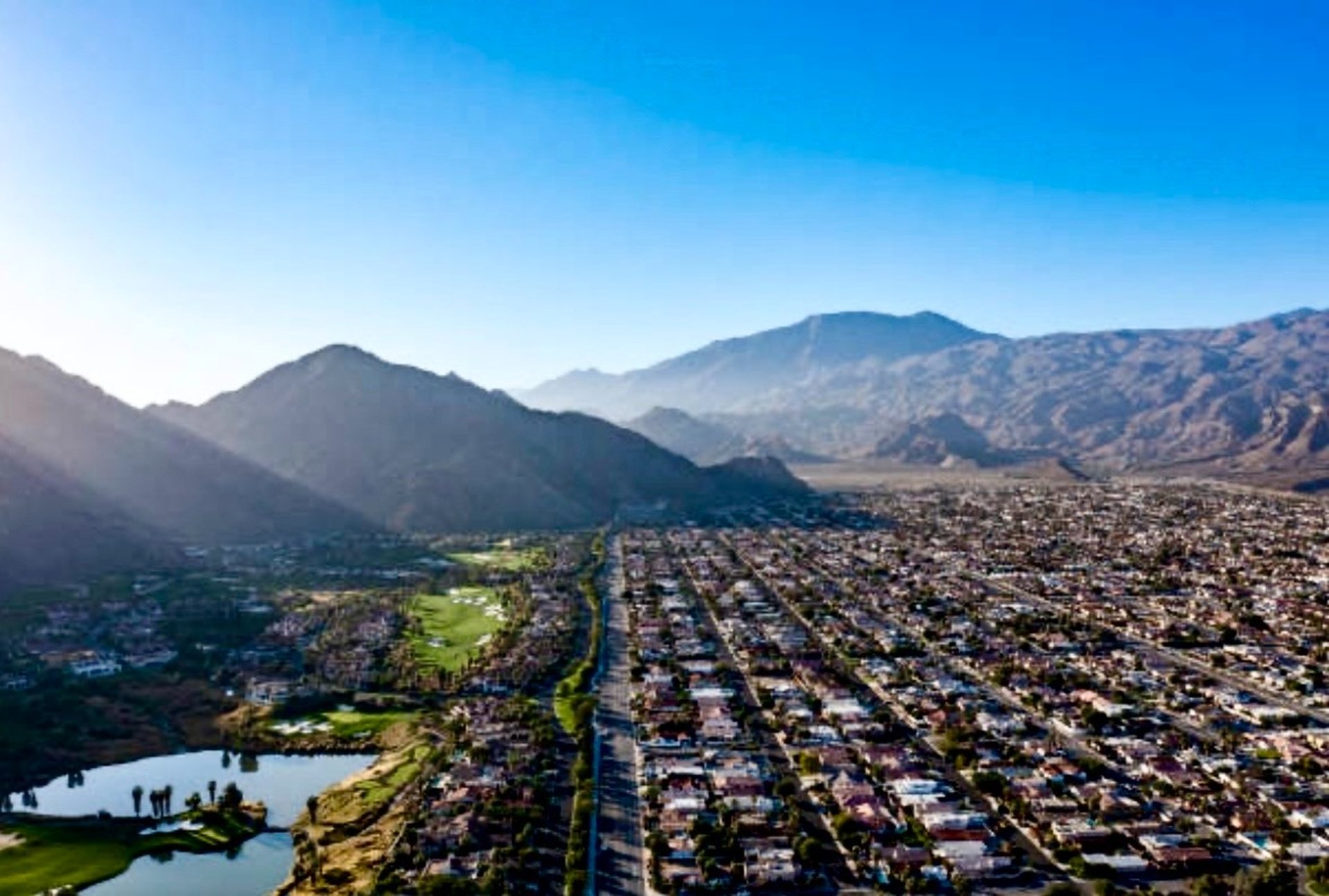 green palm trees near brown concrete building during daytime