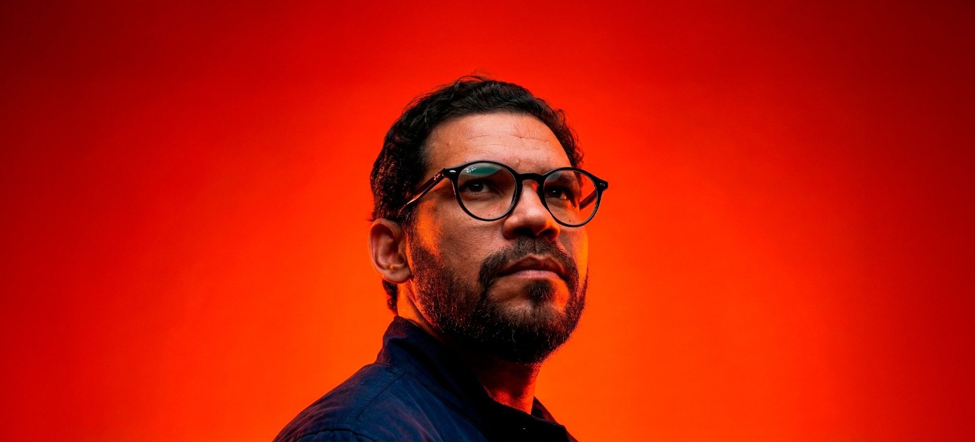 an abstract photo of a curved building with a blue sky in the background