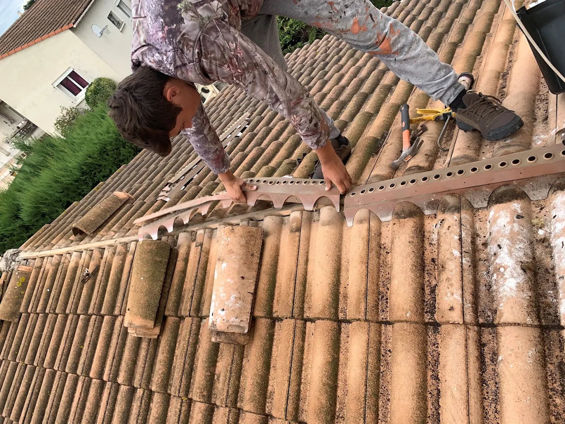 a person wearing blue gloves and holding a hammer