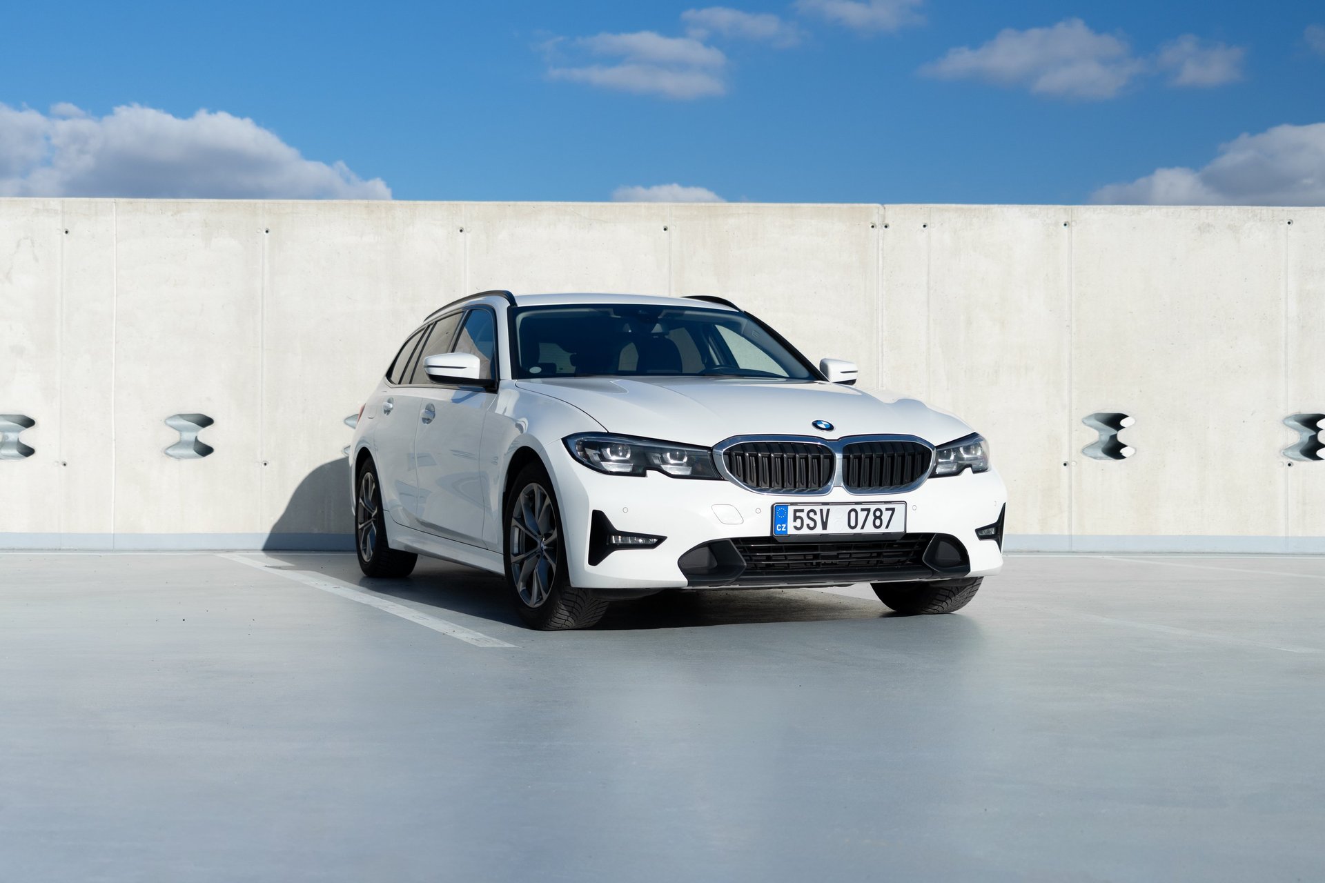 a grey car parked in front of a building