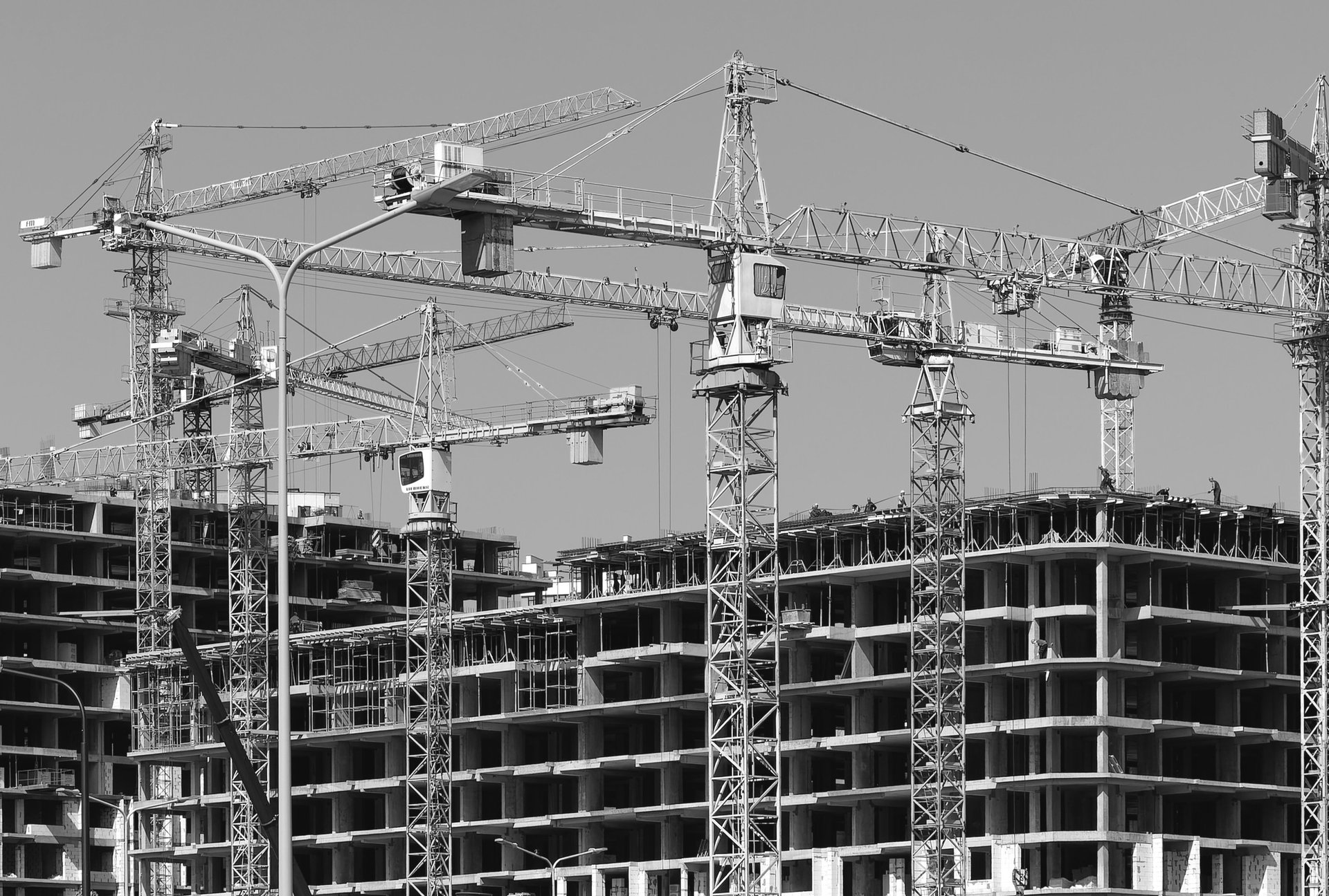 a group of cranes that are standing in the air