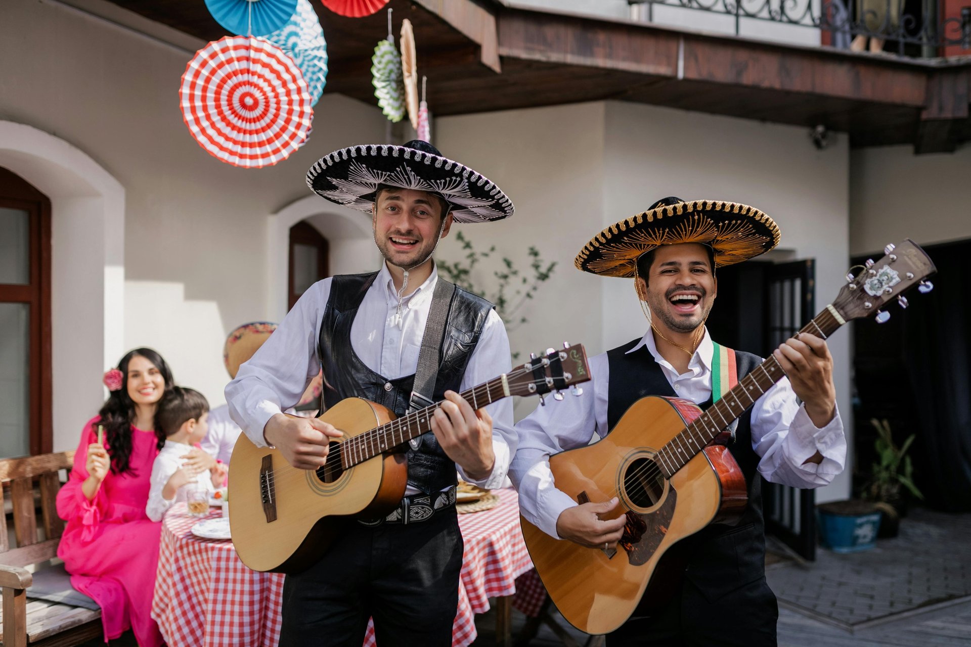 a group of men wearing red hats and holding drinks