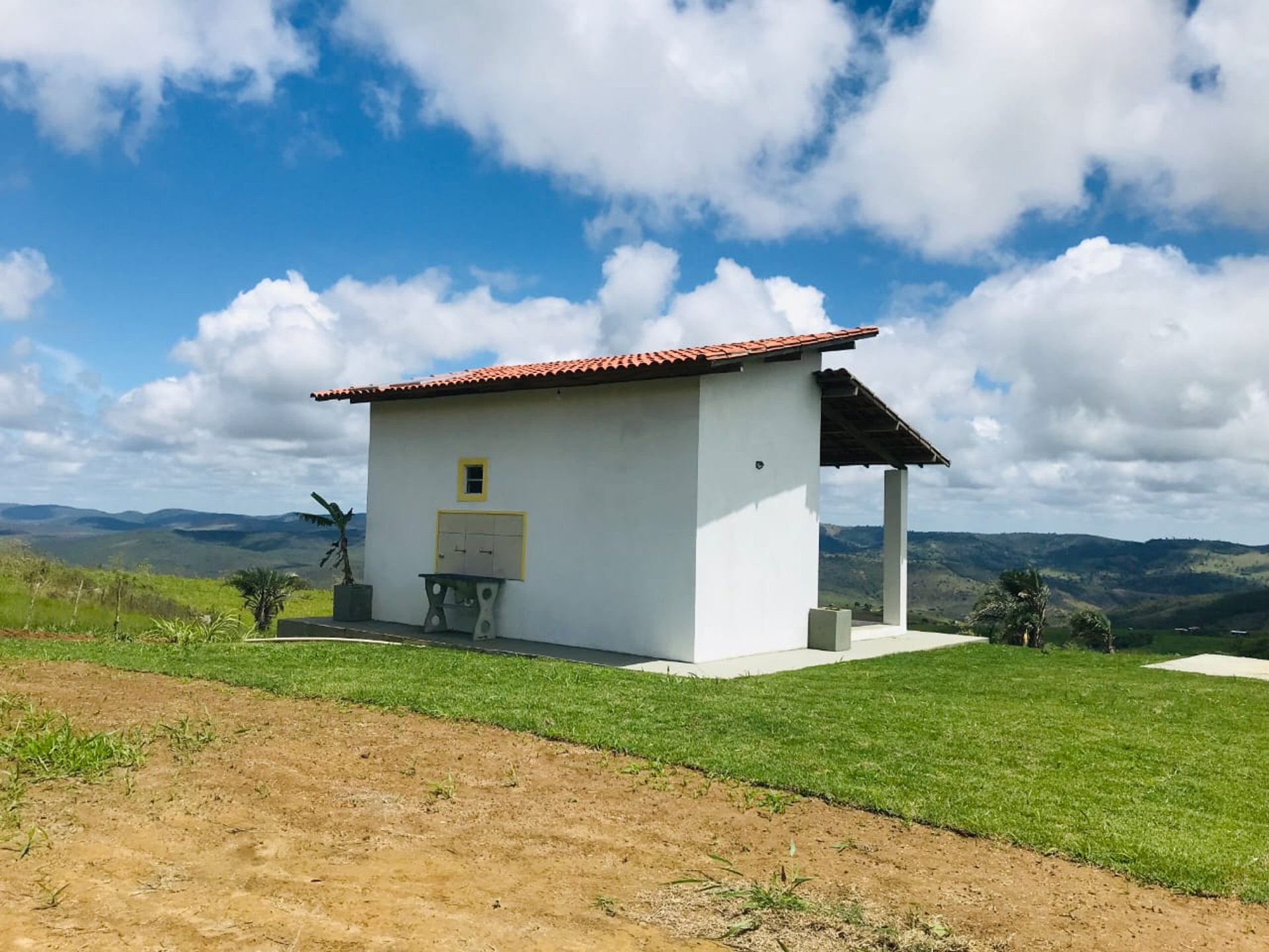 woman wearing yellow long-sleeved dress under white clouds and blue sky during daytime