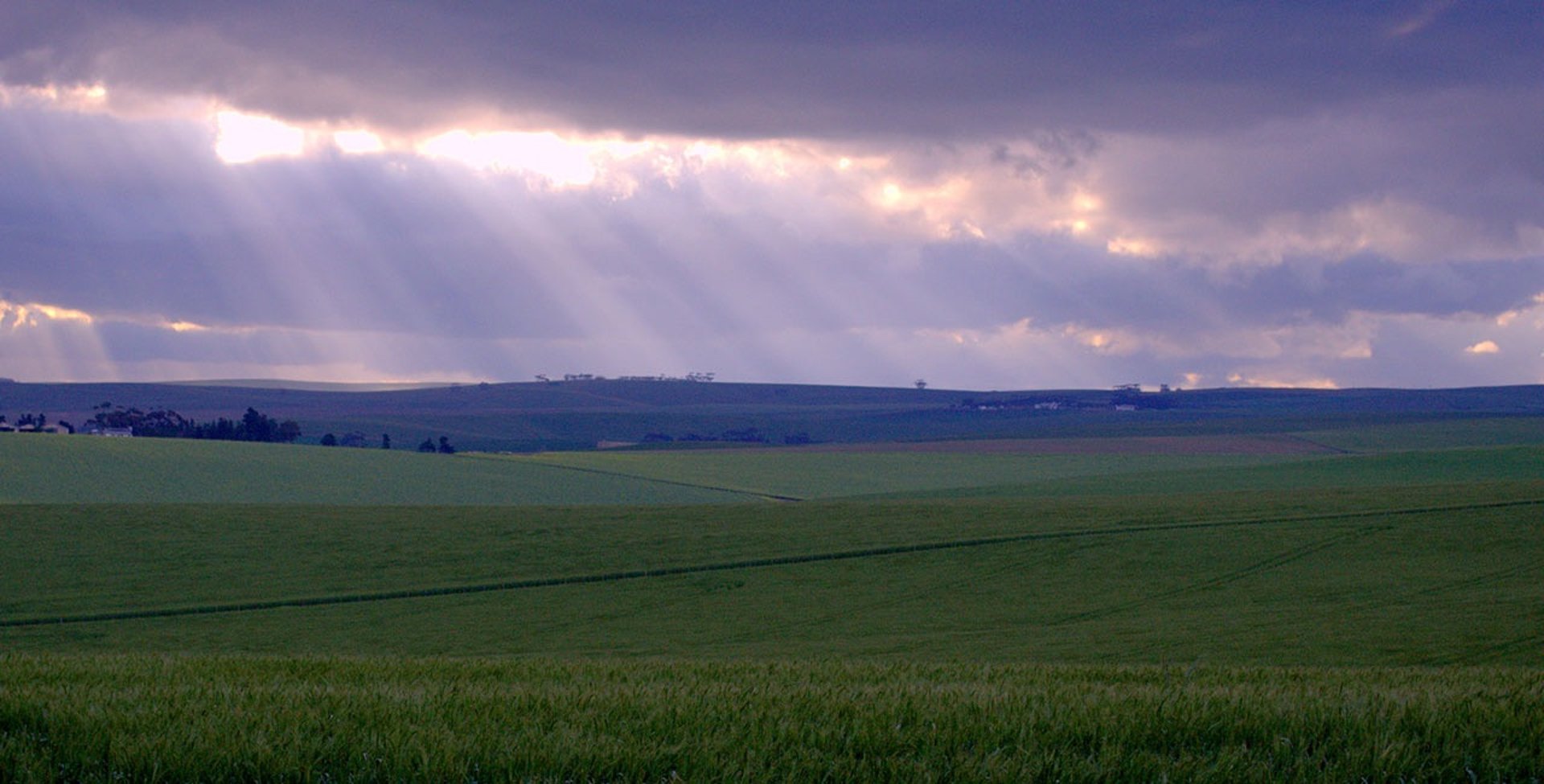 free field landscape shot with light coming through clouds