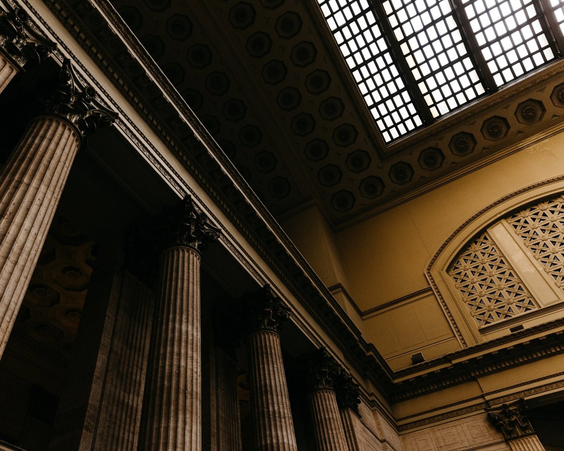 an abstract photo of a curved building with a blue sky in the background