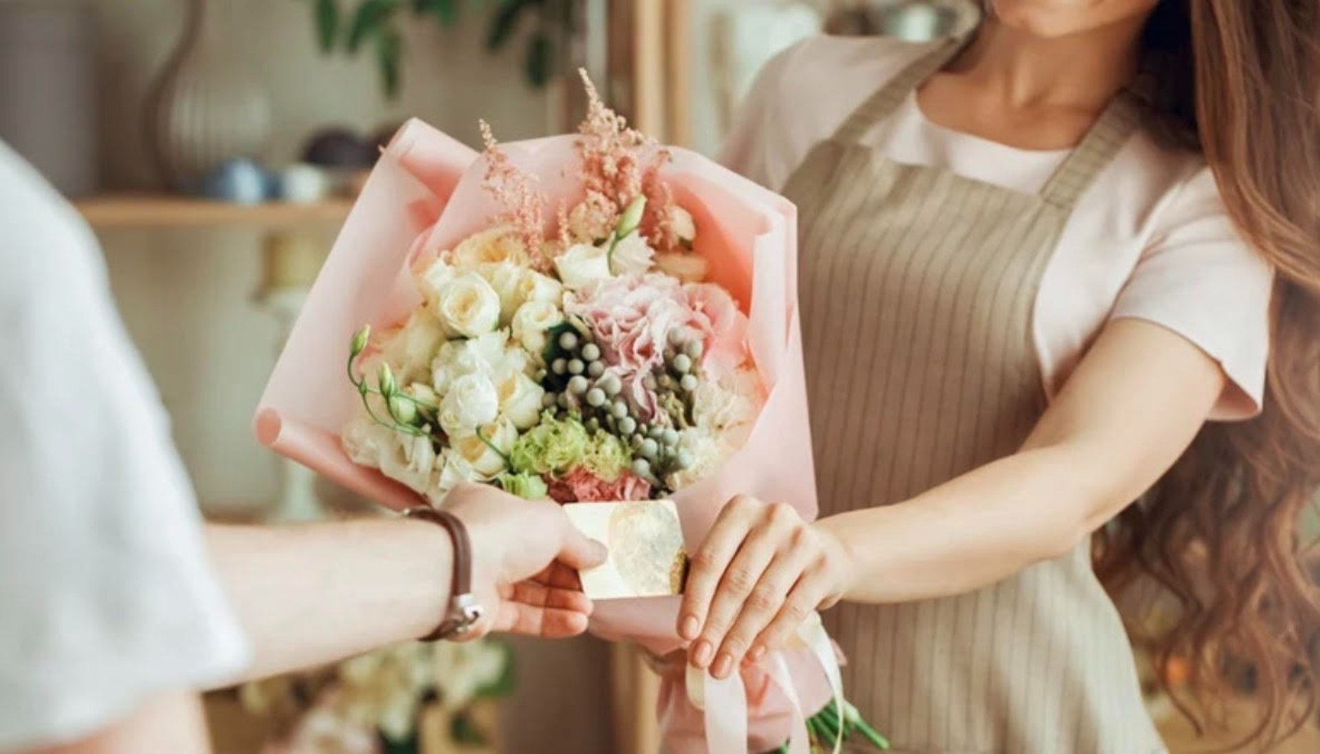 pink and white flowers on brown wooden table