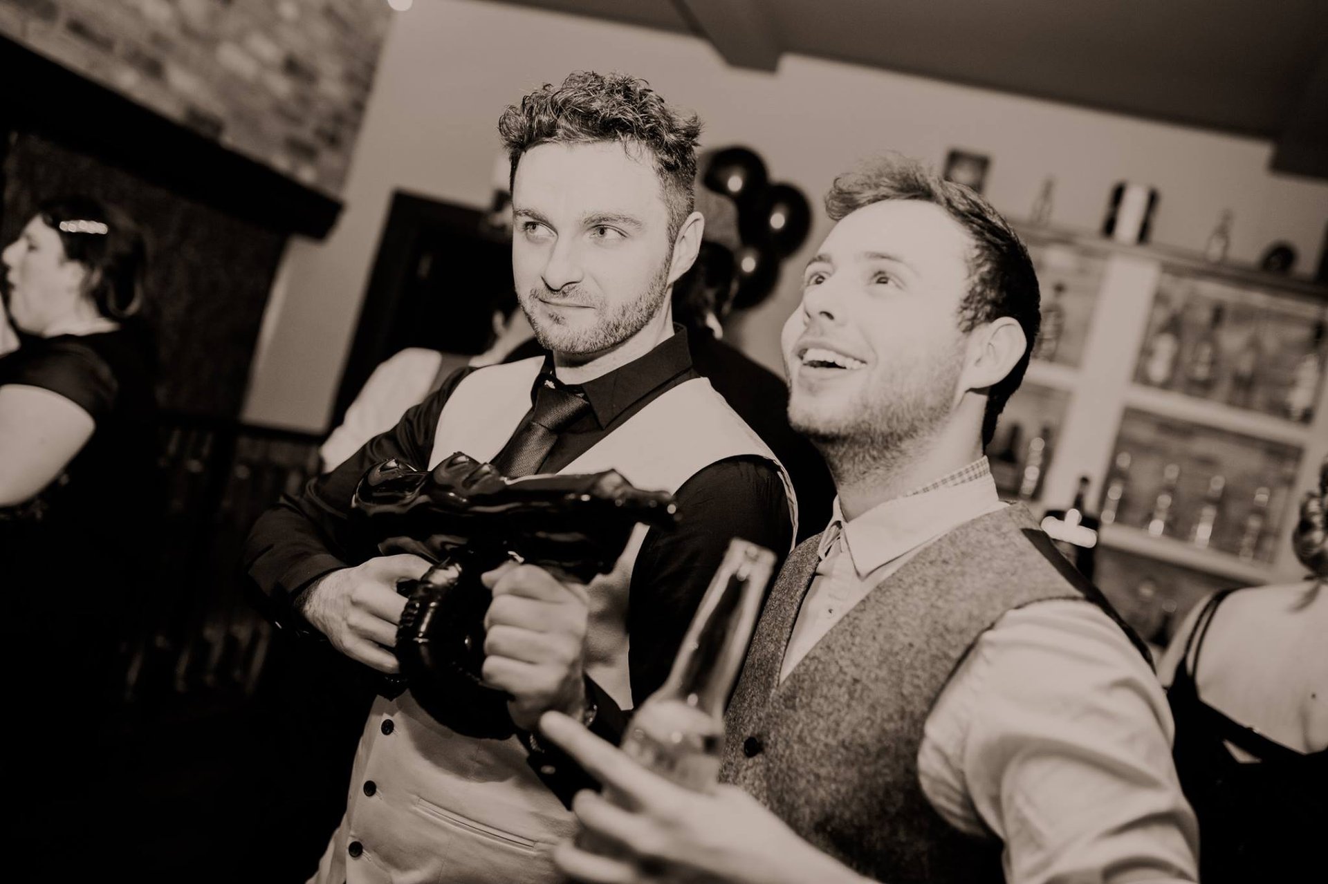 two men dressed in 1920s costume for a murder mystery.