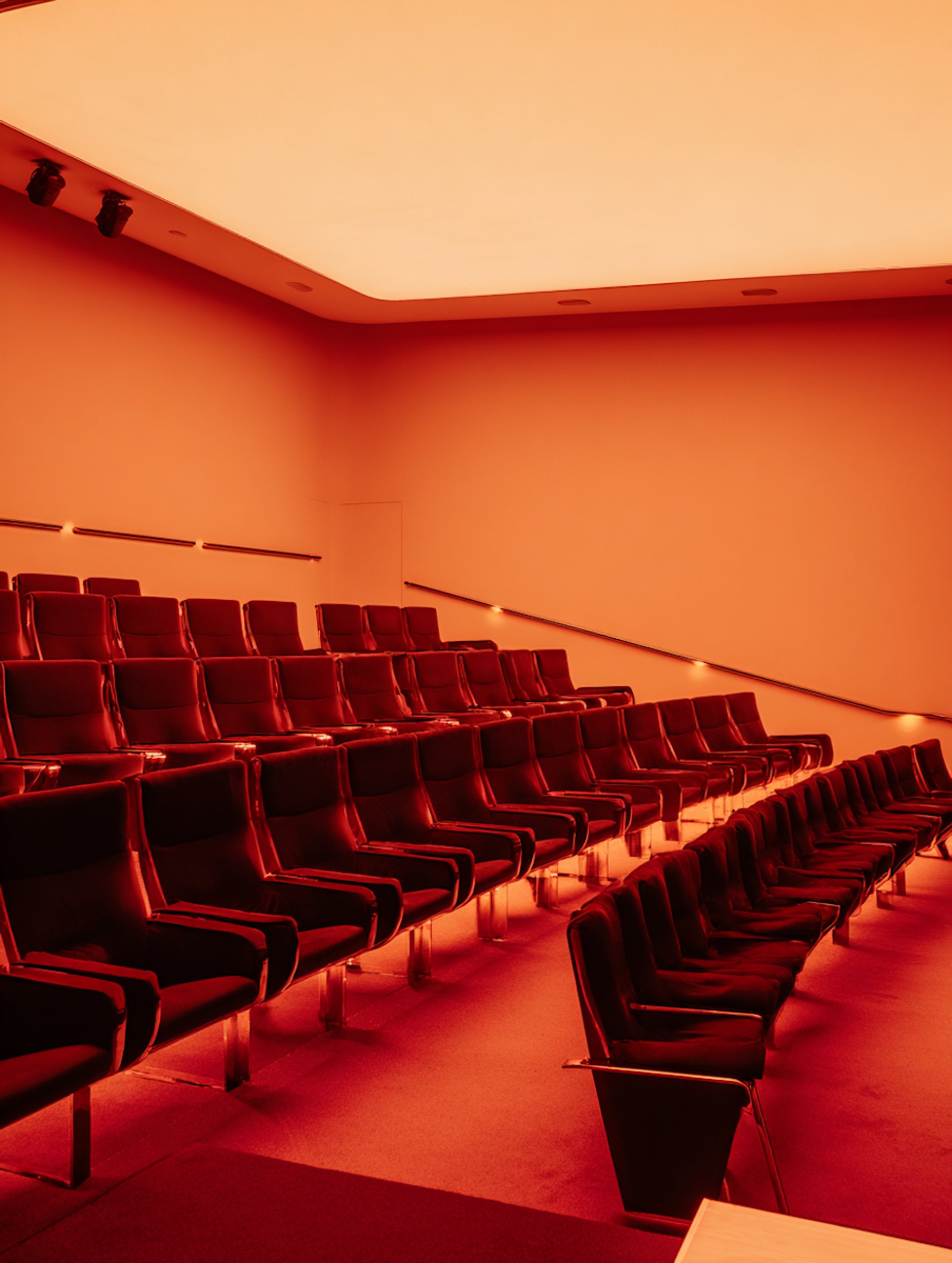 an abstract photo of a curved building with a blue sky in the background