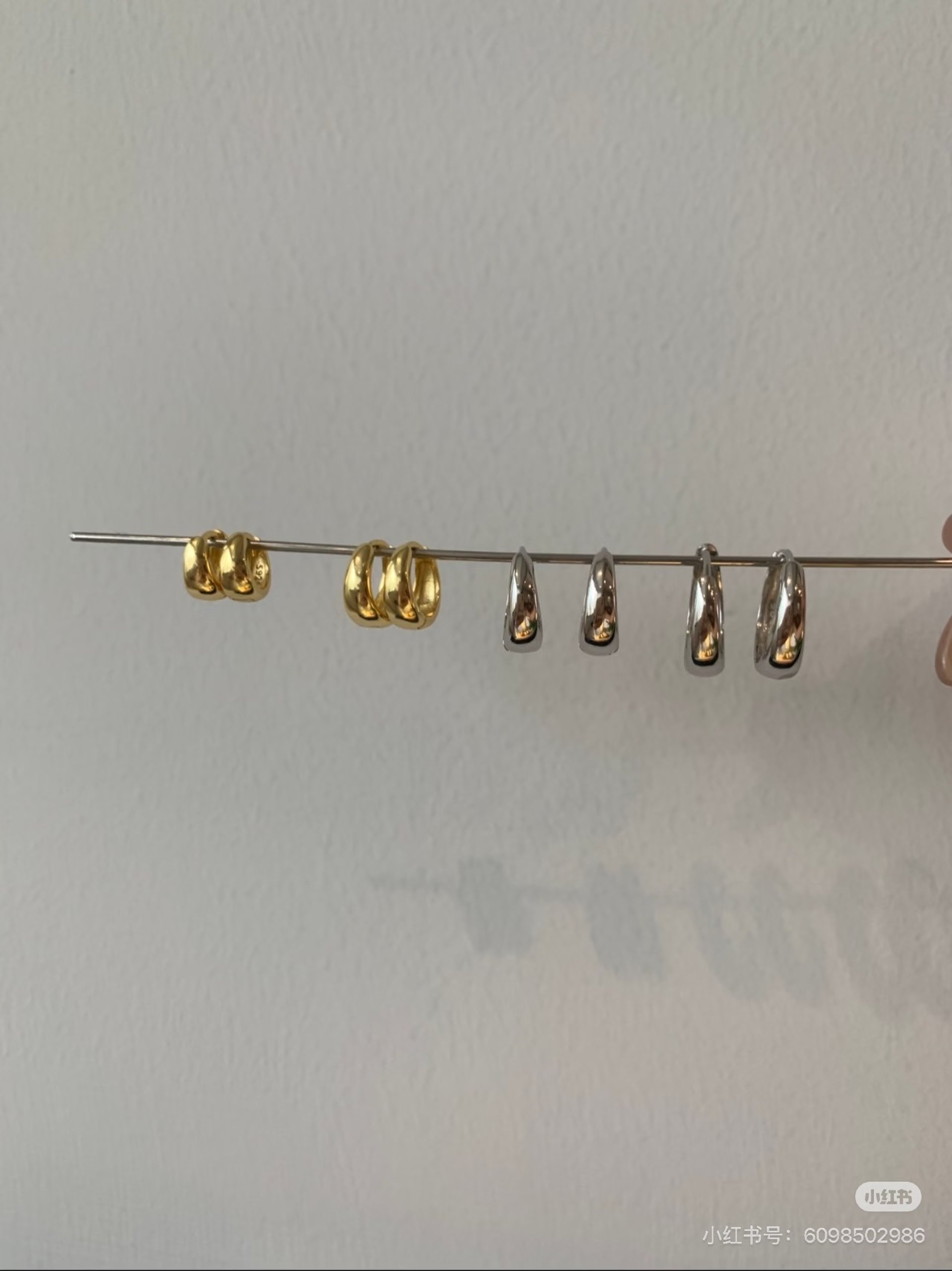 woman in black blazer wearing gold necklace