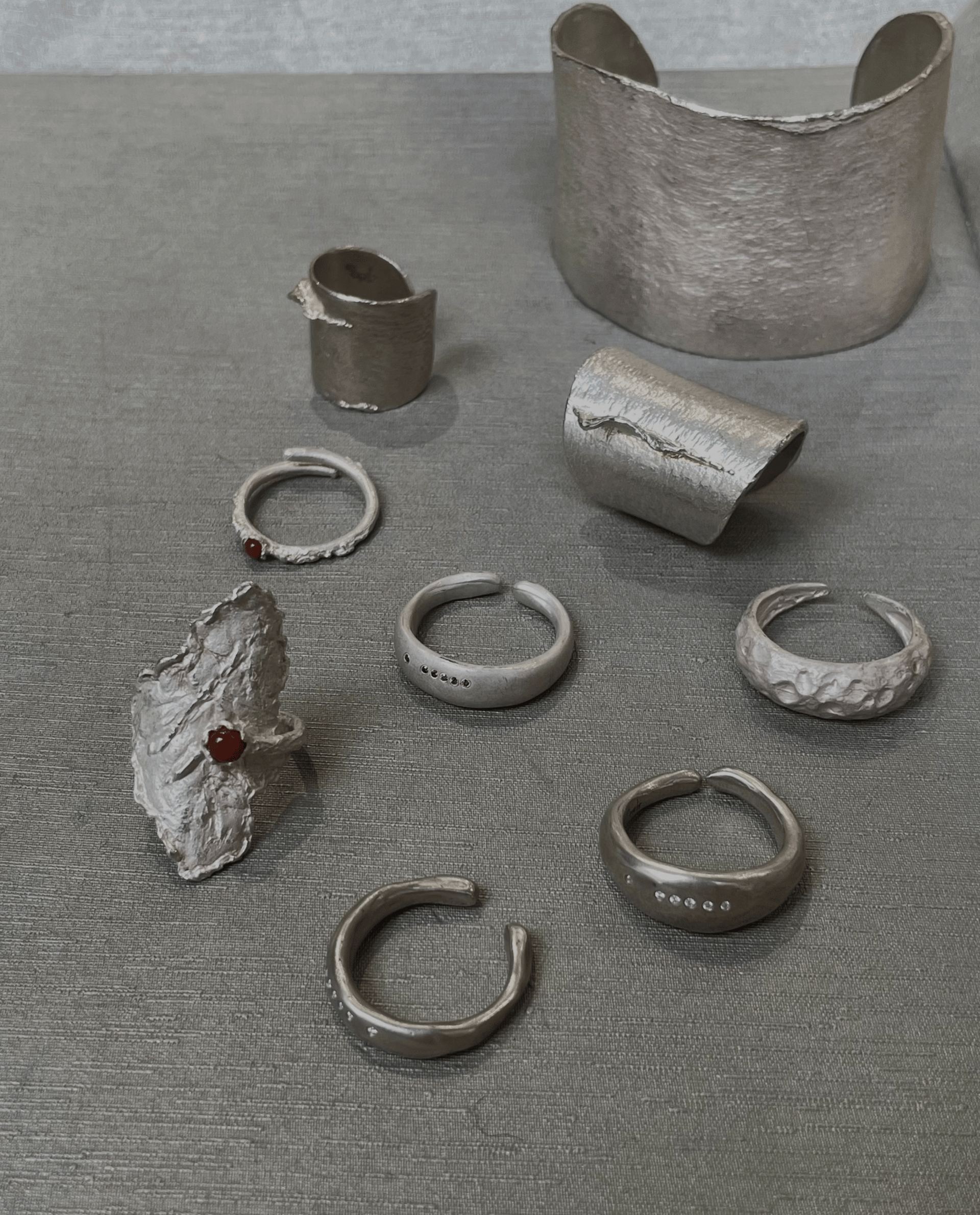 Two sun-shaped necklaces displayed on a bust.