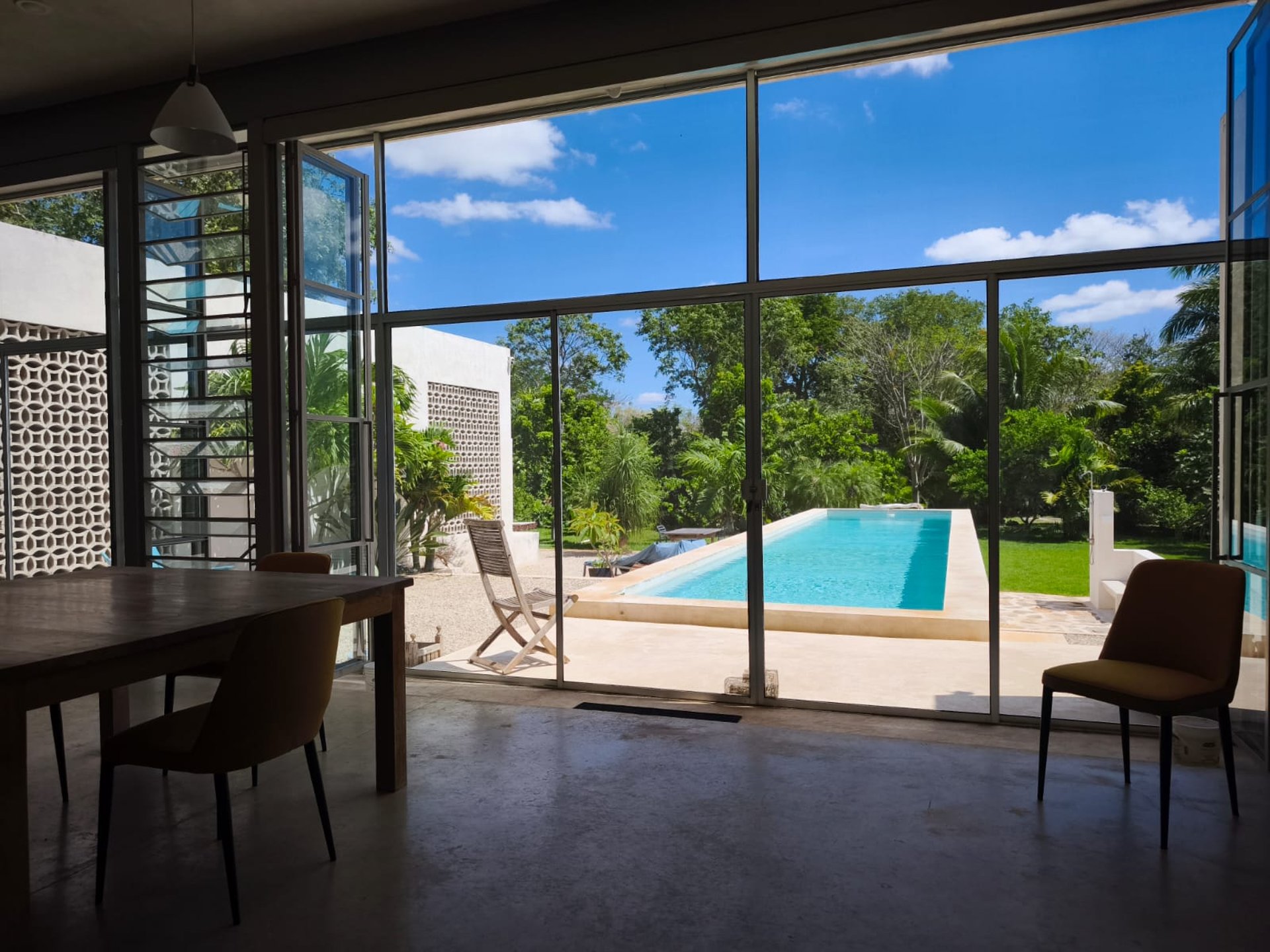 woman wearing yellow long-sleeved dress under white clouds and blue sky during daytime