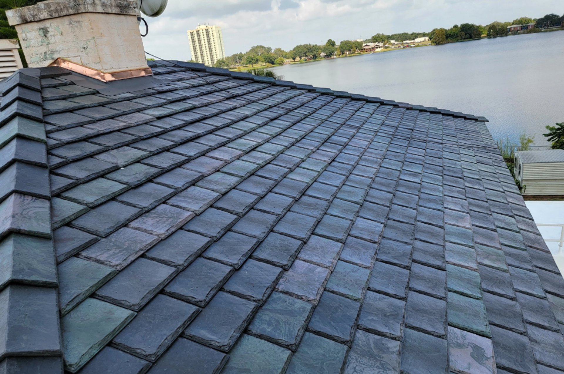 a man on a roof working with a rope