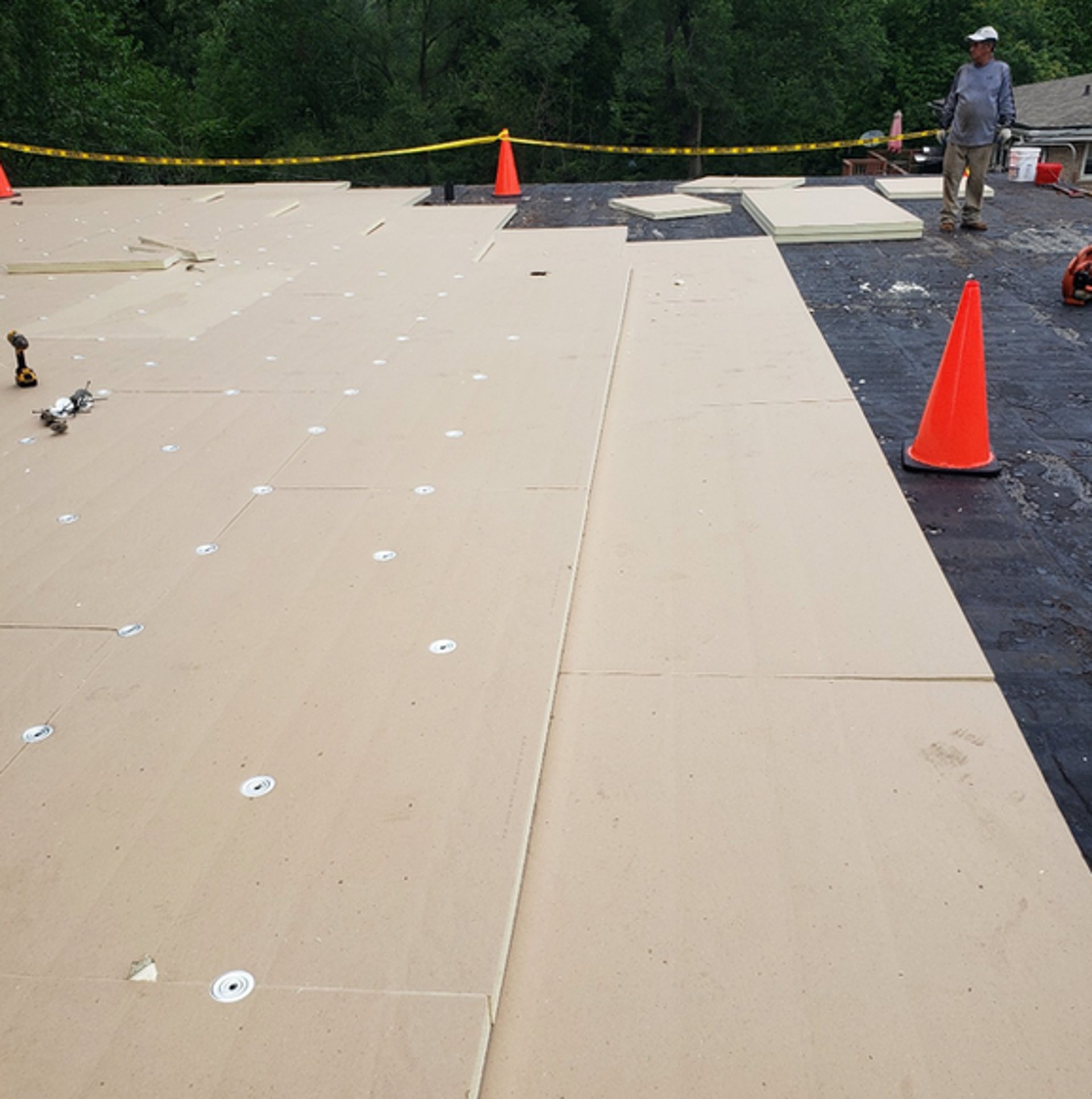 a man with a hammer on top of a roof