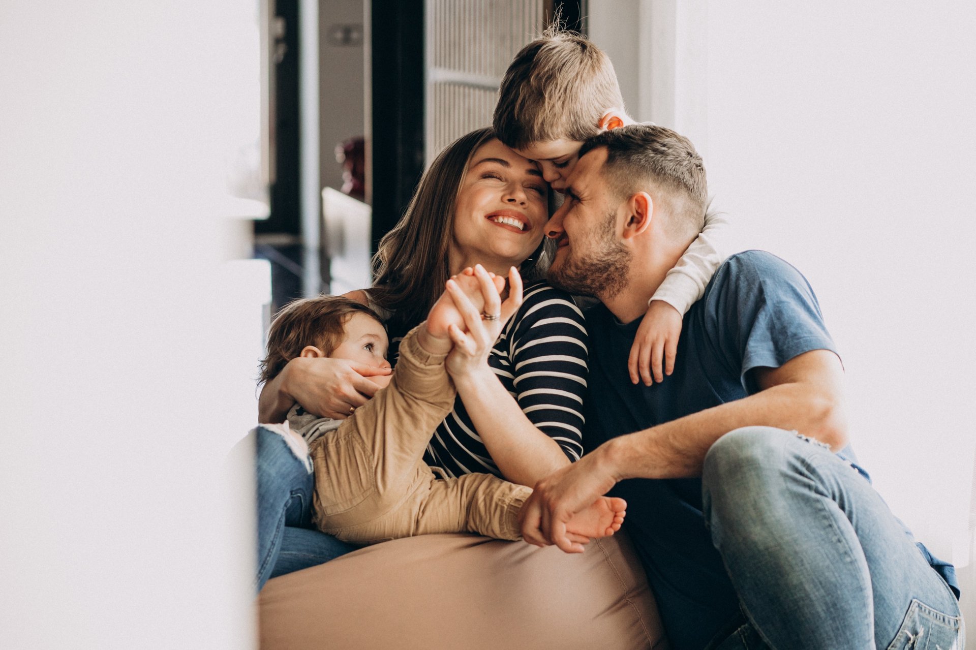 a man and woman sitting on a couch with a baby