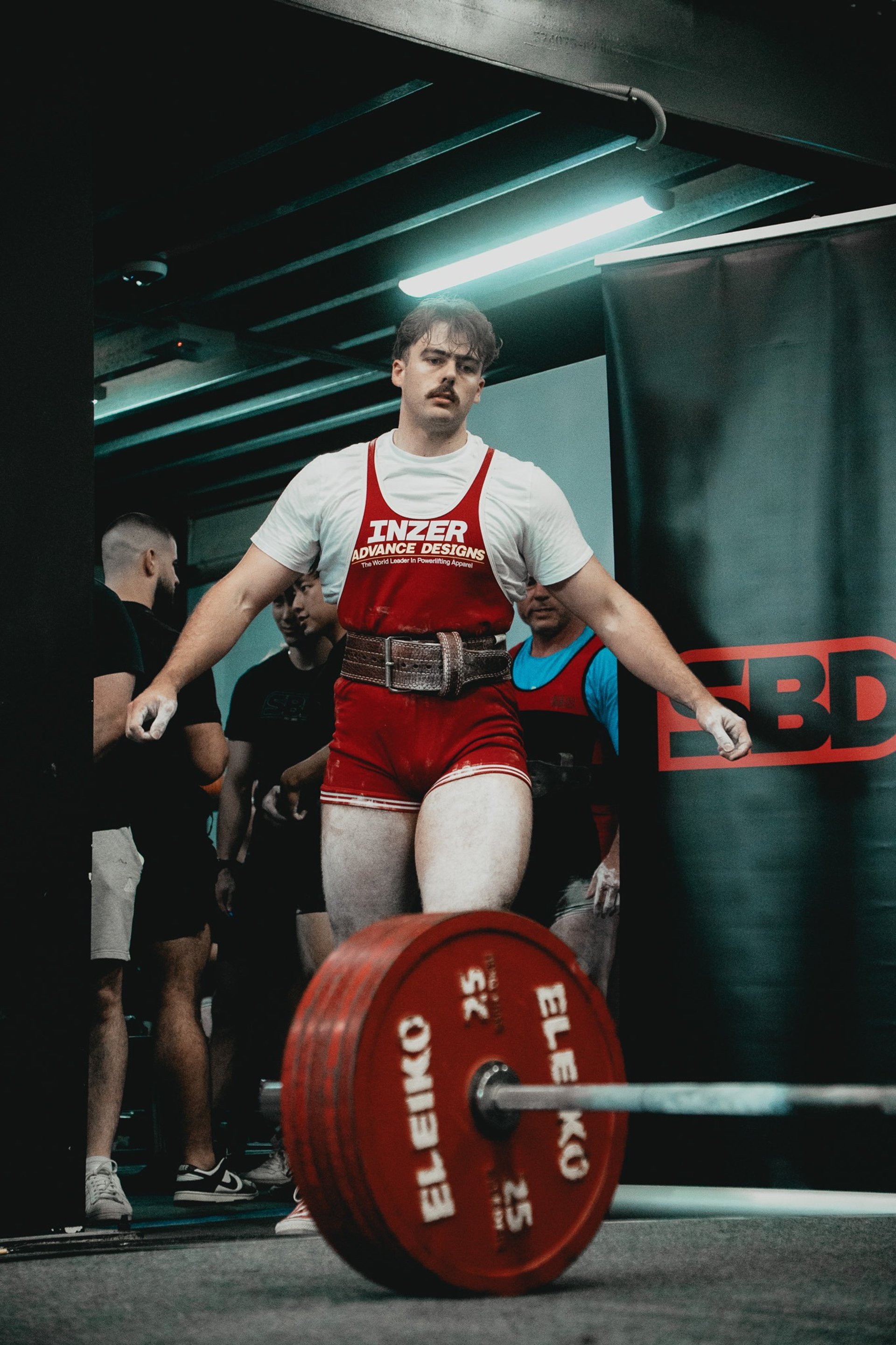 an abstract photo of a curved building with a blue sky in the background