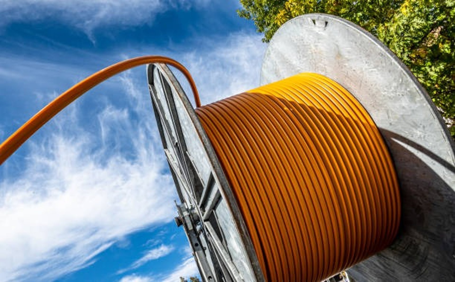 an abstract photo of a curved building with a blue sky in the background