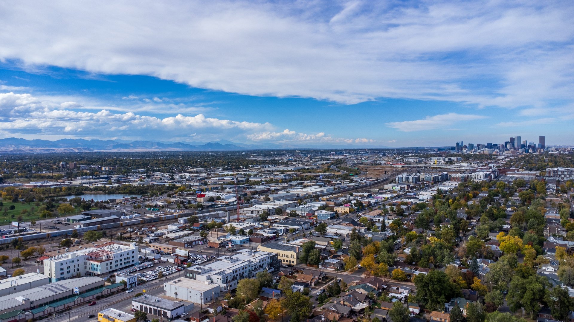 woman wearing yellow long-sleeved dress under white clouds and blue sky during daytime