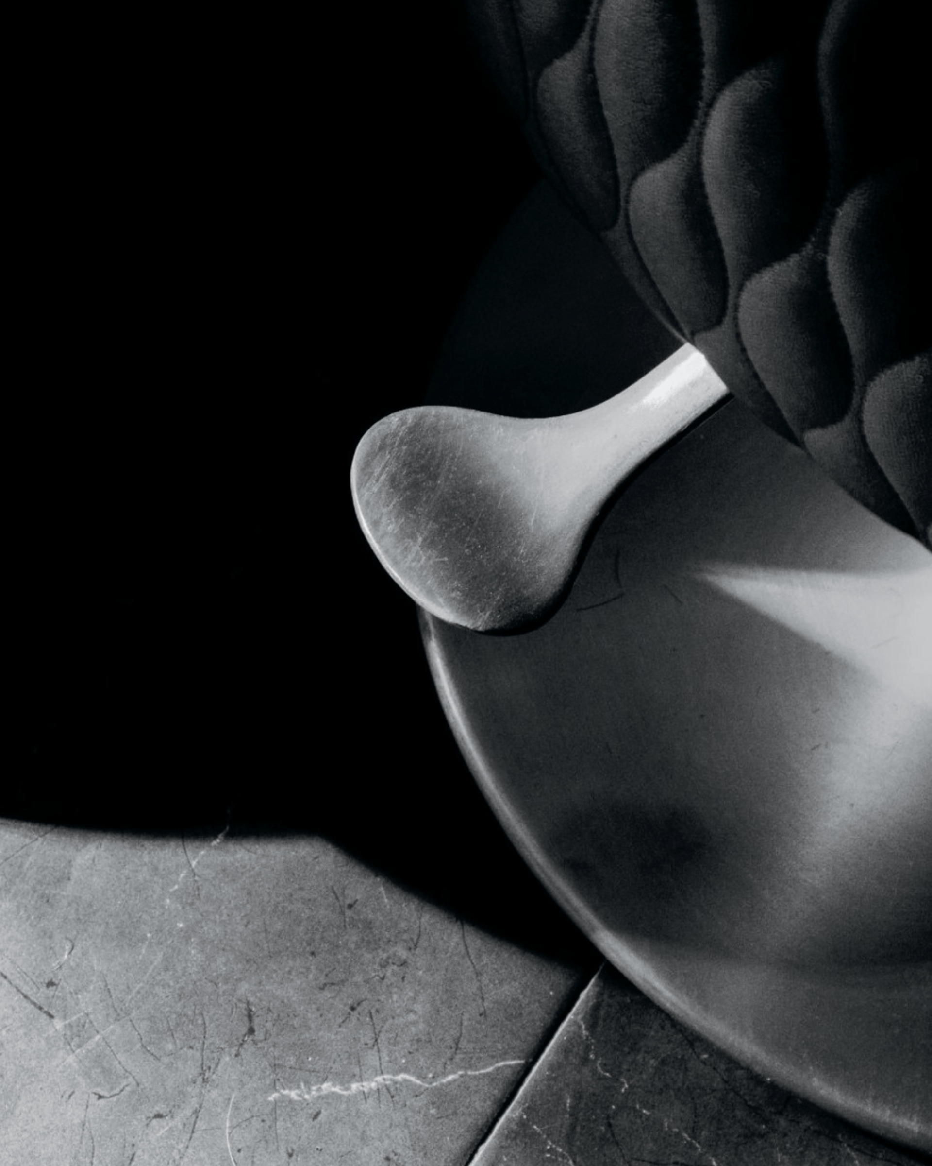 an abstract photo of a curved building with a blue sky in the background