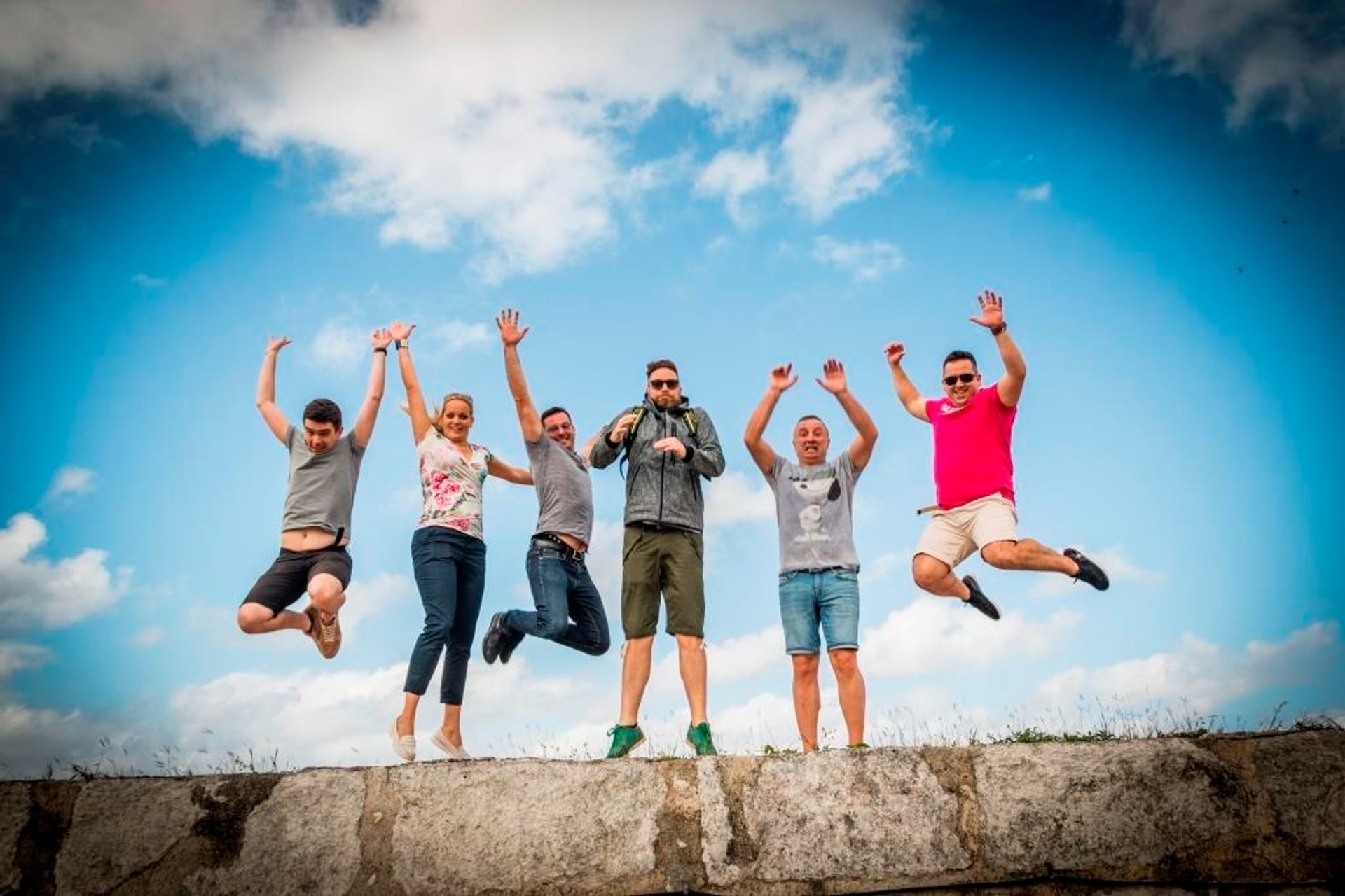 woman wearing yellow long-sleeved dress under white clouds and blue sky during daytime