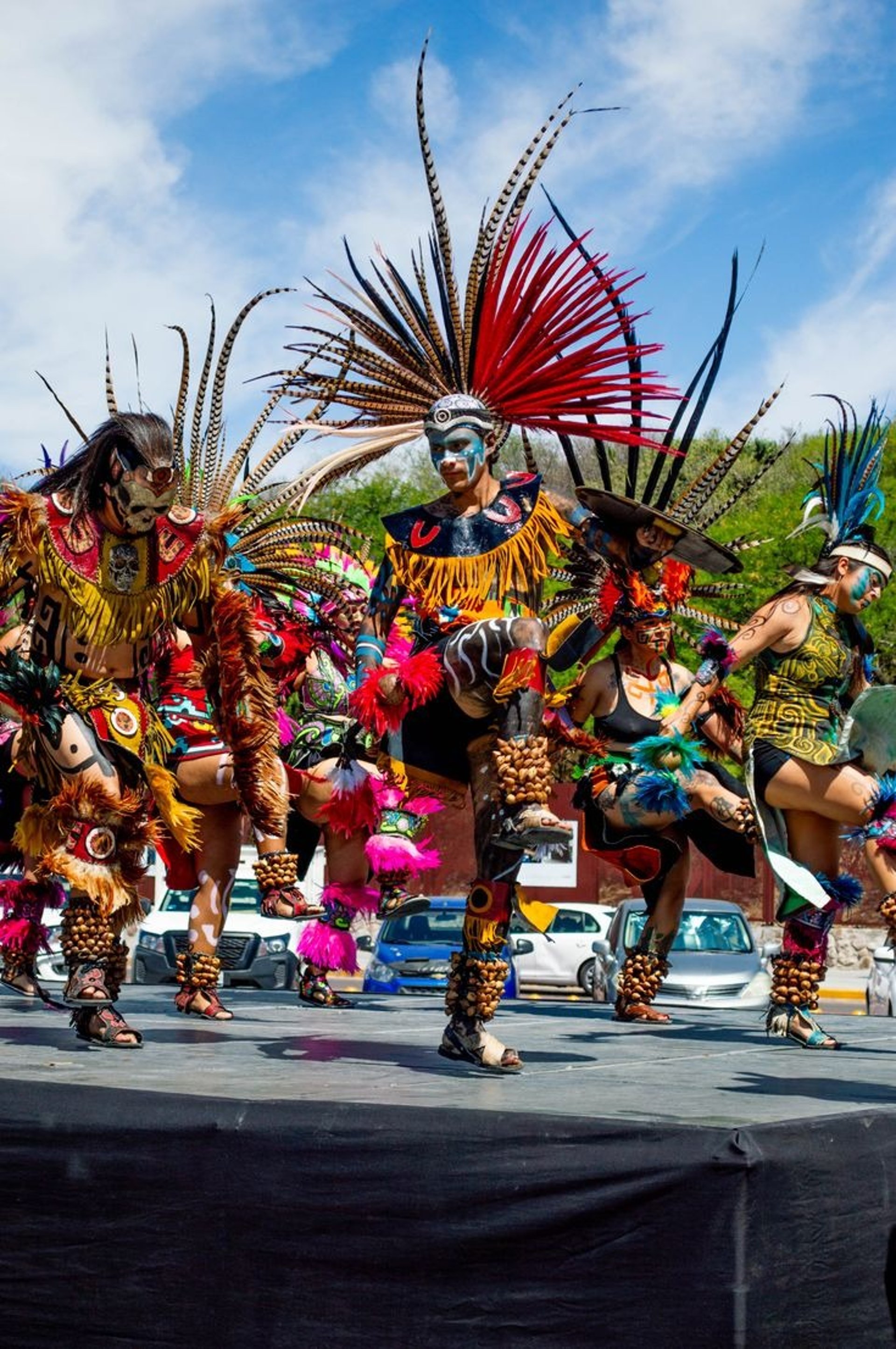 woman wearing yellow long-sleeved dress under white clouds and blue sky during daytime