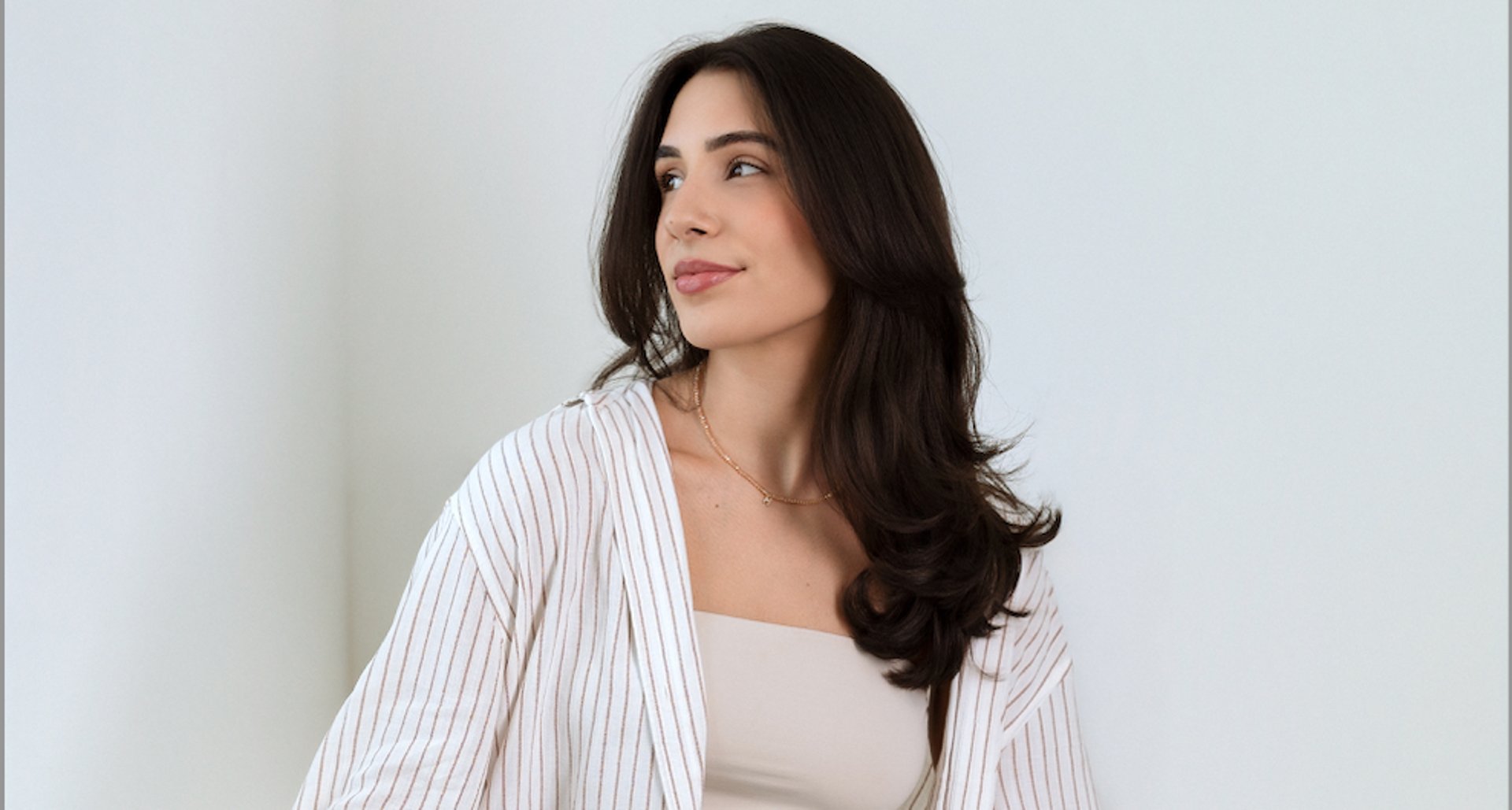 woman wearing yellow long-sleeved dress under white clouds and blue sky during daytime