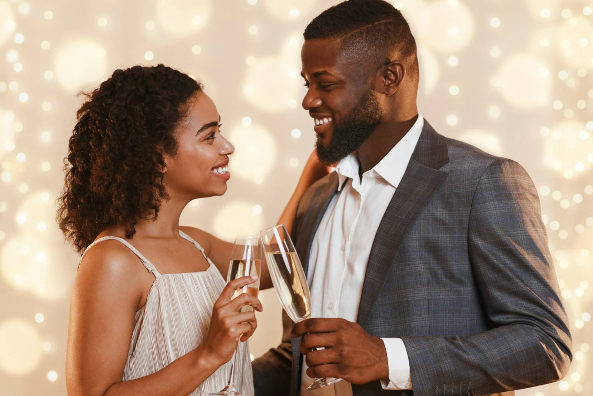 a couple embracing each other in front of trees