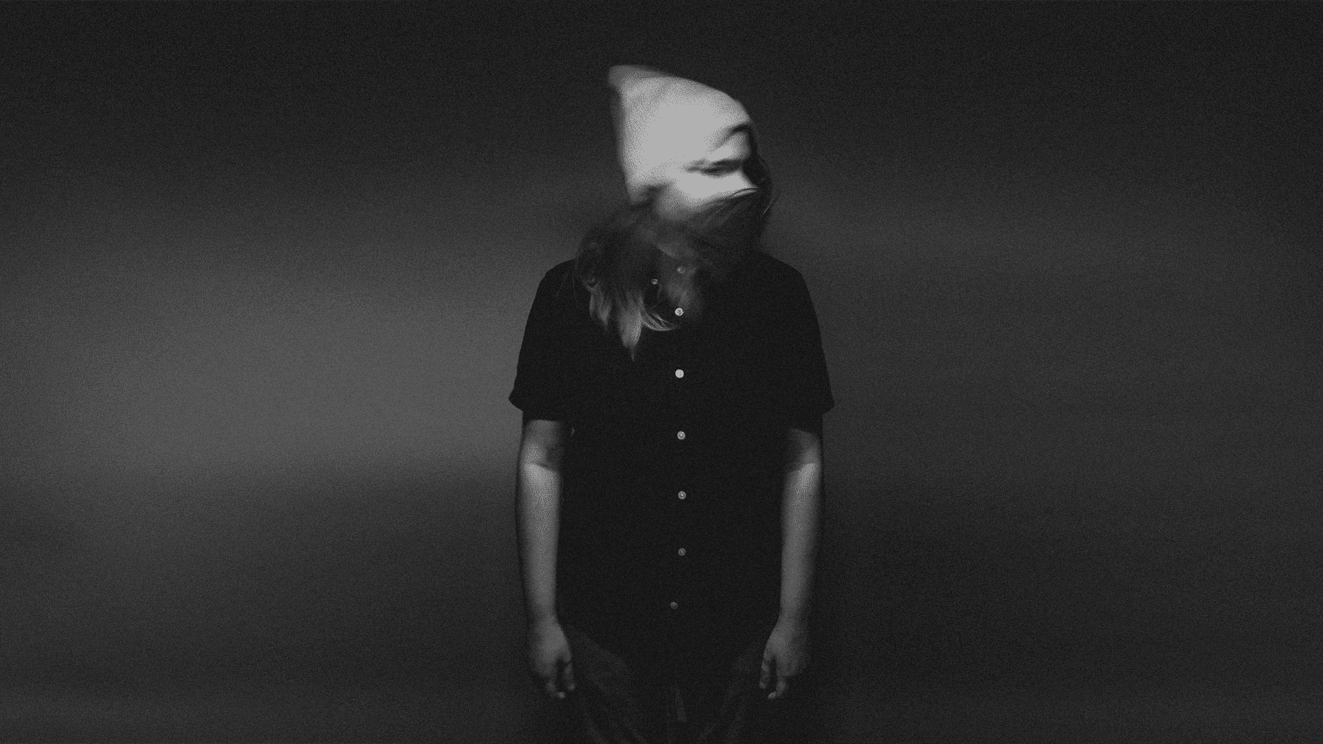 an abstract photo of a curved building with a blue sky in the background