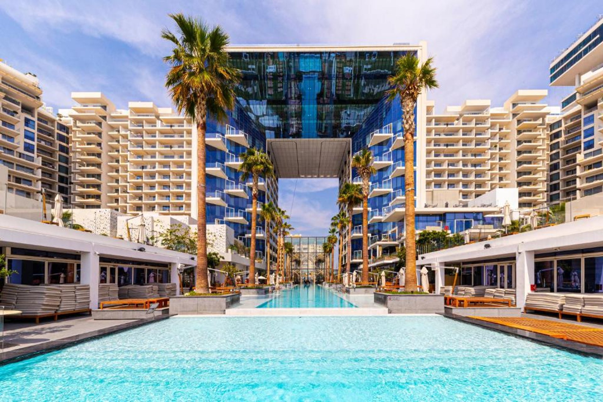 an abstract photo of a curved building with a blue sky in the background