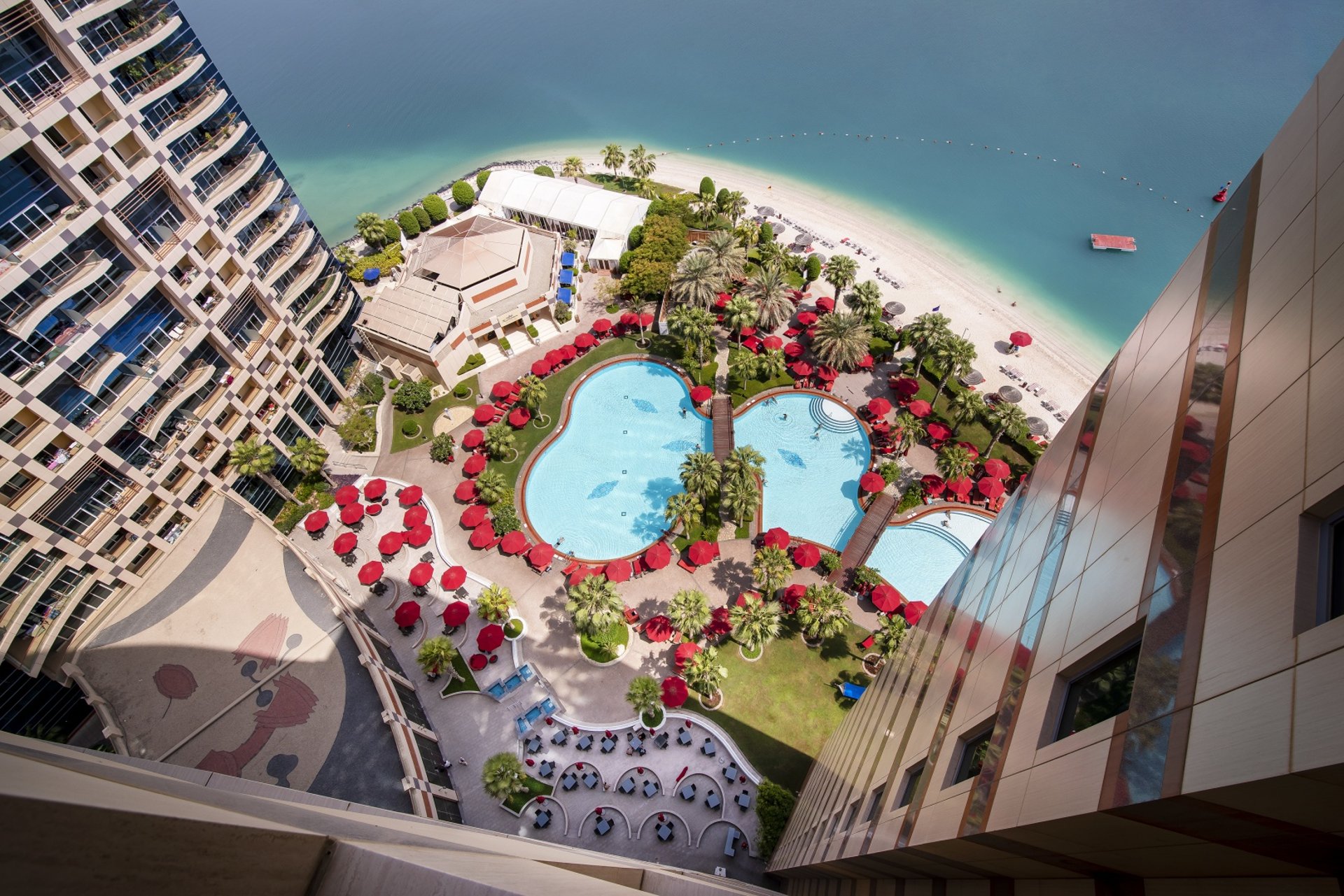 an abstract photo of a curved building with a blue sky in the background
