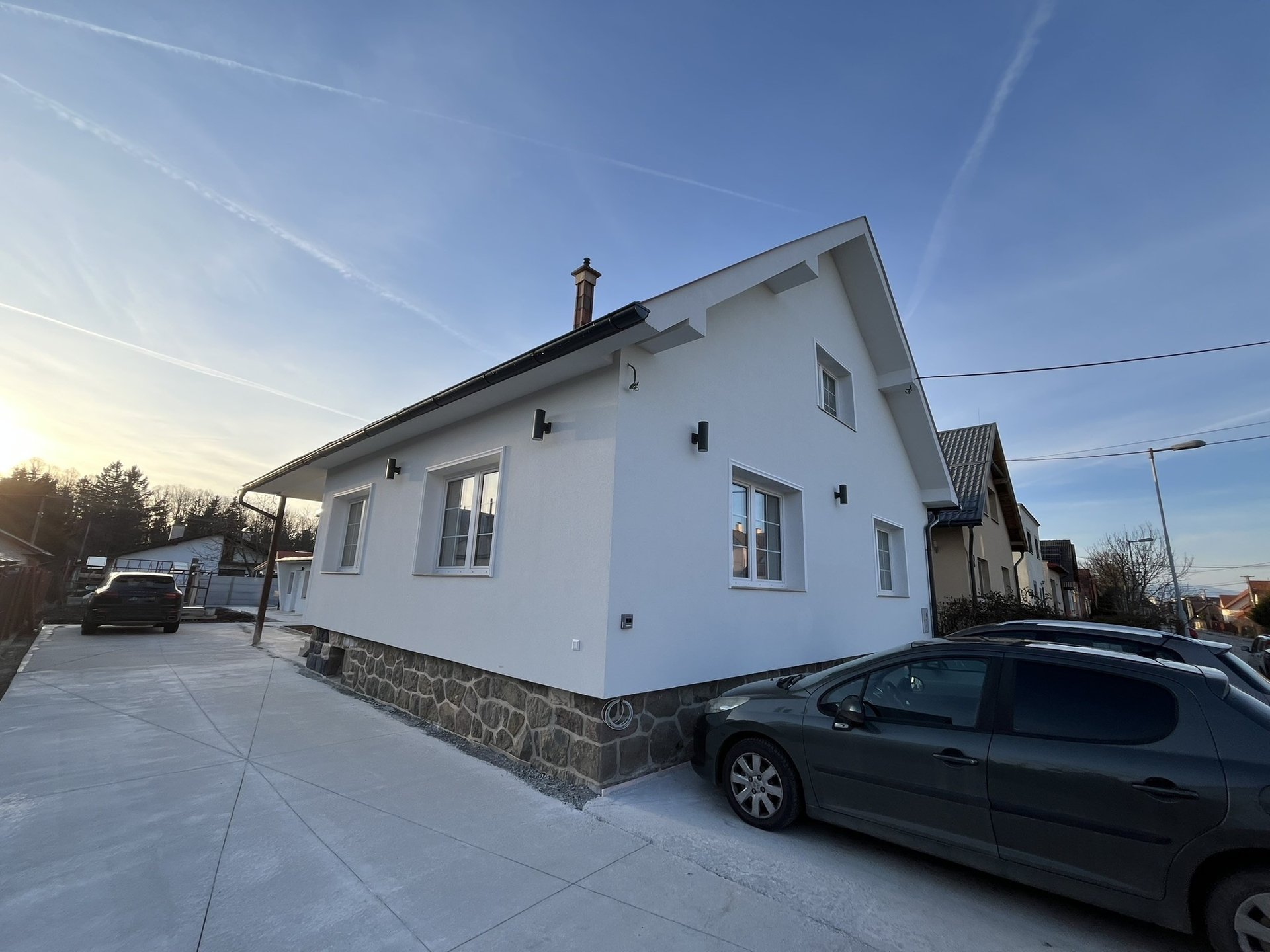 white and red wooden house miniature on brown table