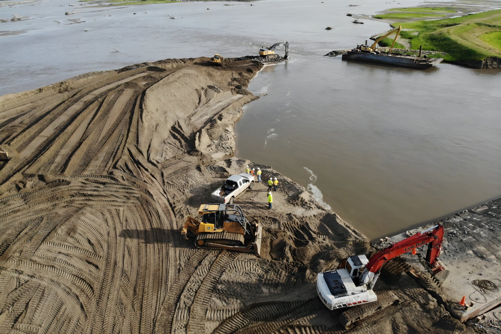 aerial photography of three heavy equipment