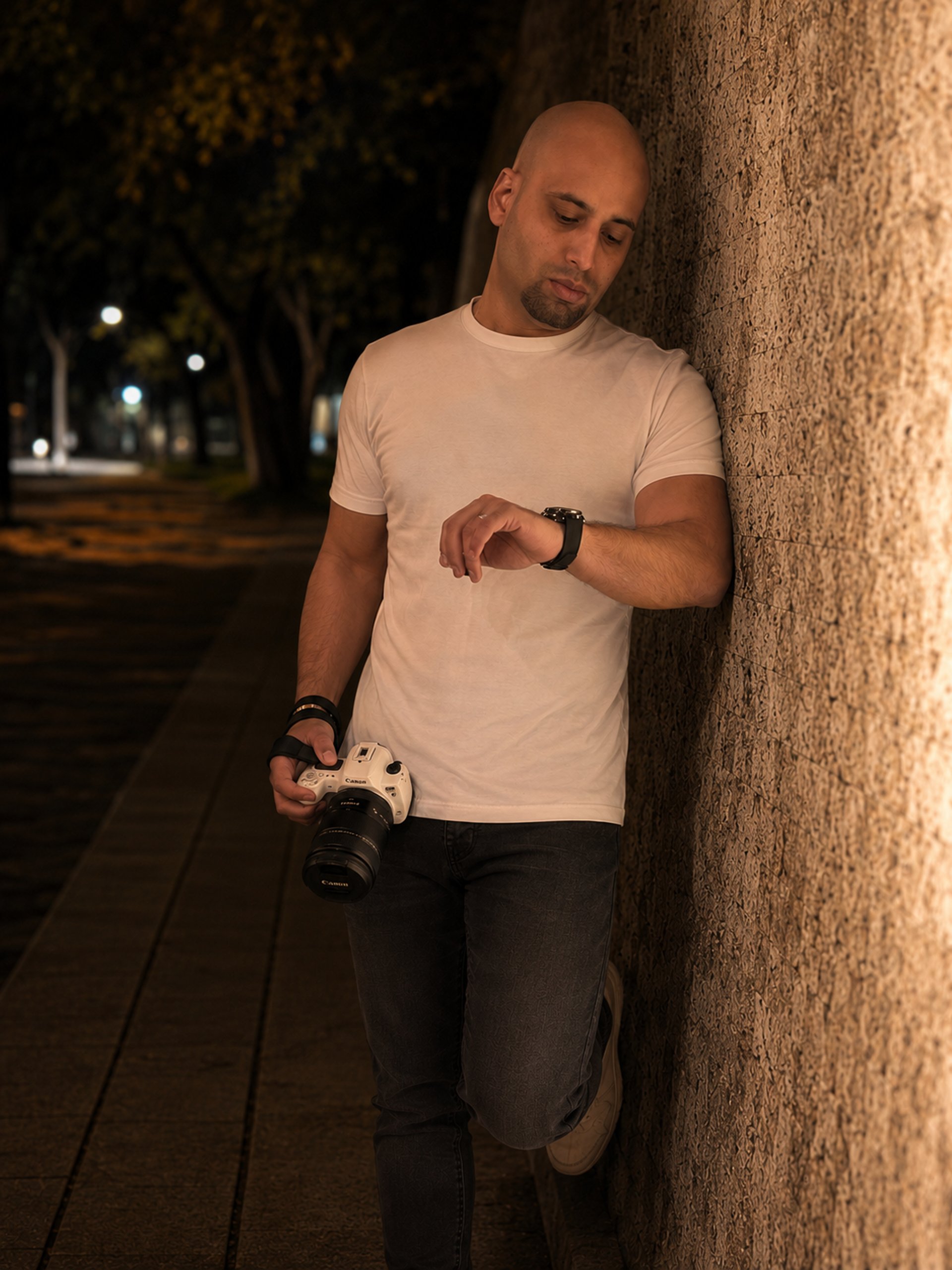 a man kneeling down holding a camera