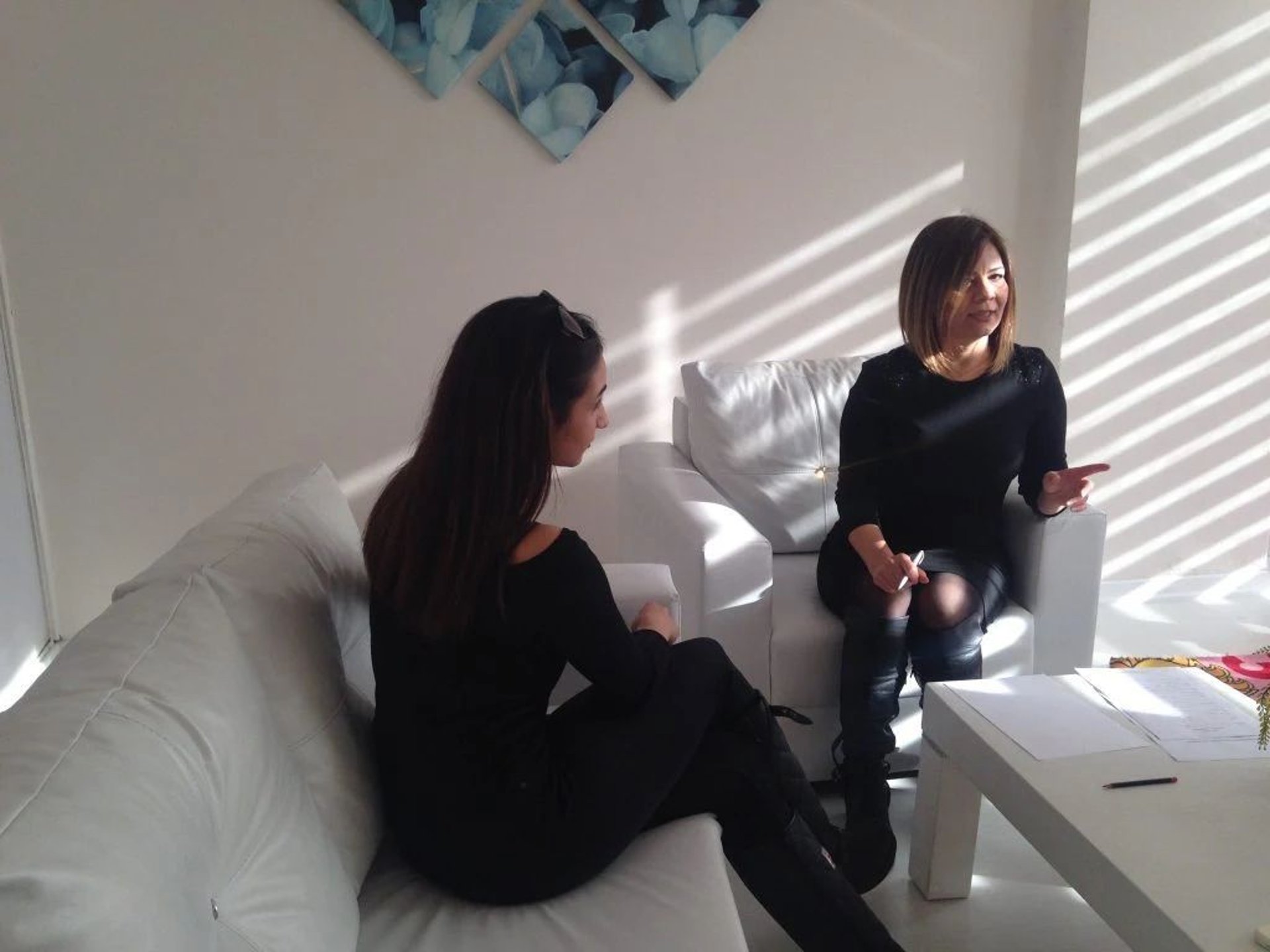 woman in white sweater sitting on chair