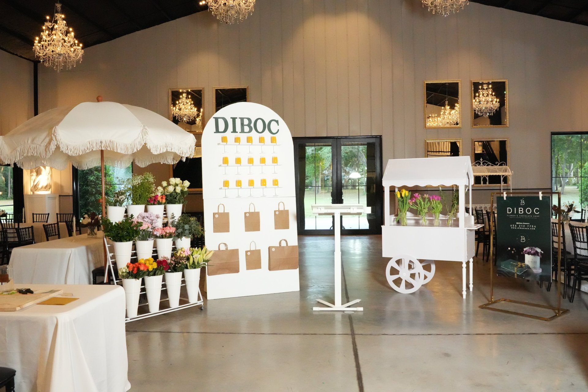 Elegant DIBOC flower and chocolate experience setup with floral displays and tasting station for a luxury event in Tampa