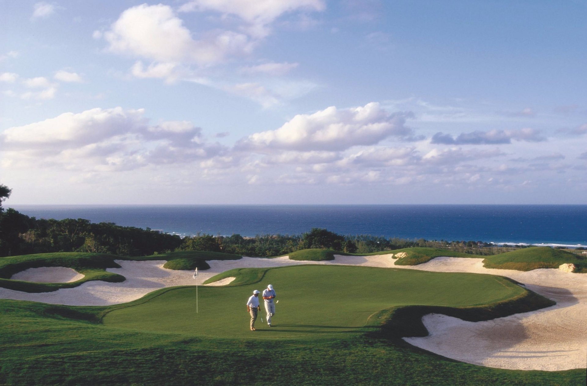 white and brown concrete building near green grass field during daytime