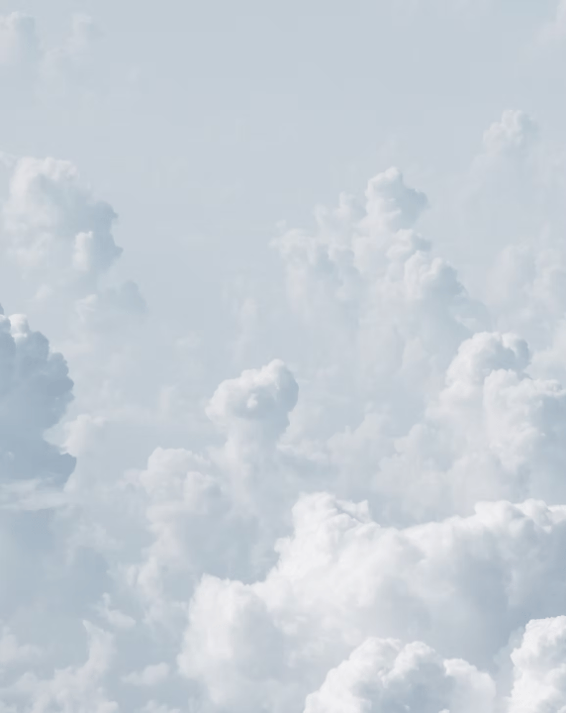 a group of people standing on a beach under a cloudy sky